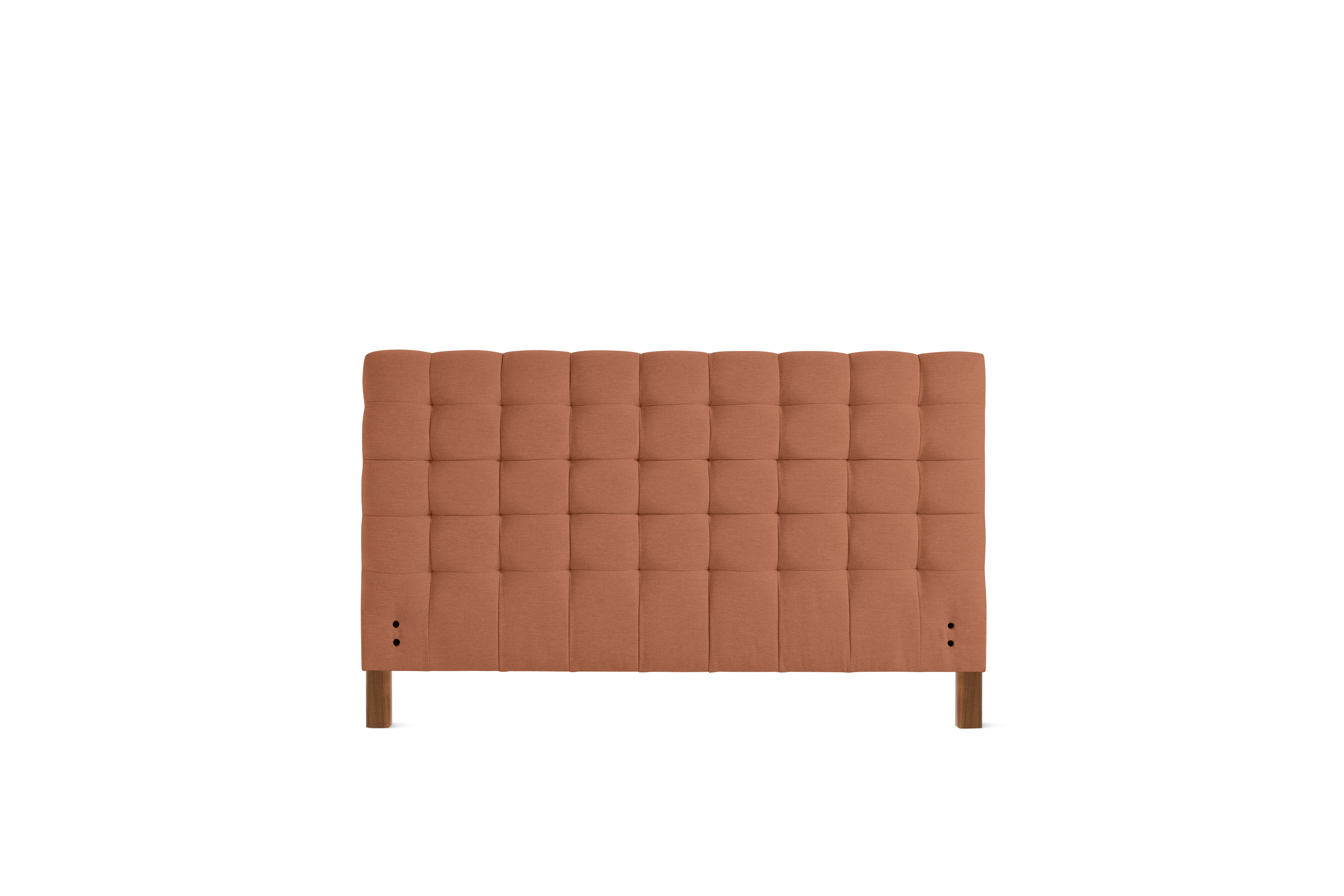 A Madeleine Headboard in Mode, Caramelized, Walnut viewed from the front.