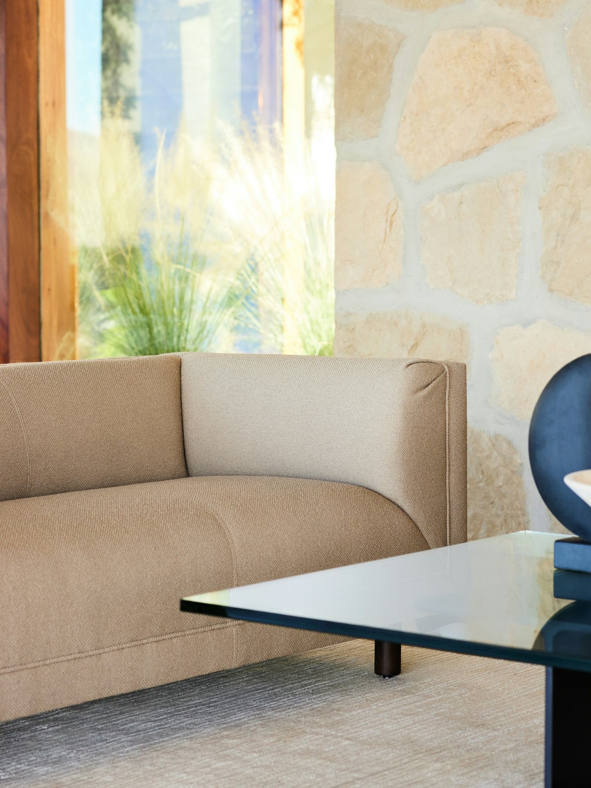 Close up detail image of a Rolled Arm Sofa and I Beam Coffee Table in an environmental setting.