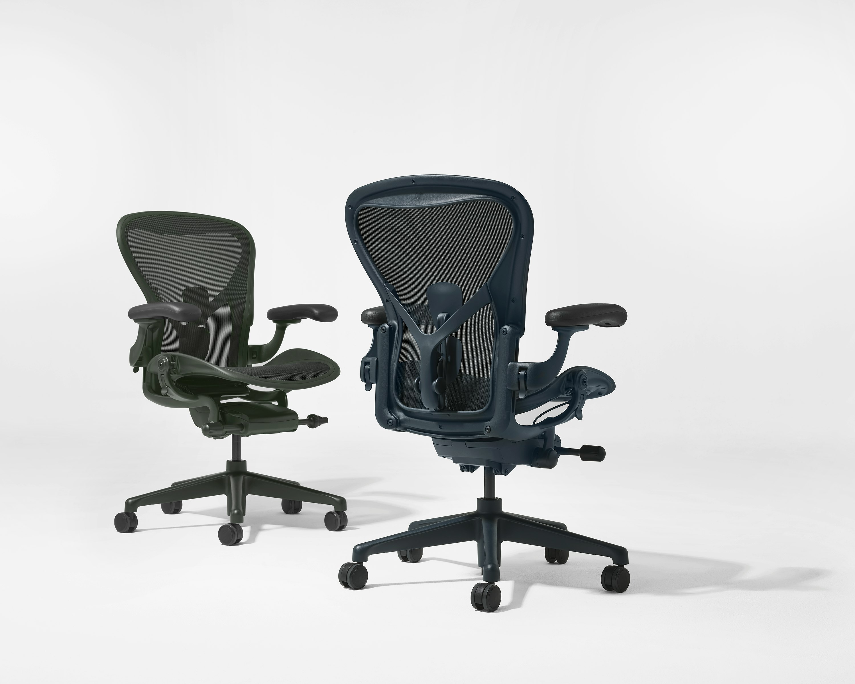 Aeron chairs in dark green and navy beside each other.