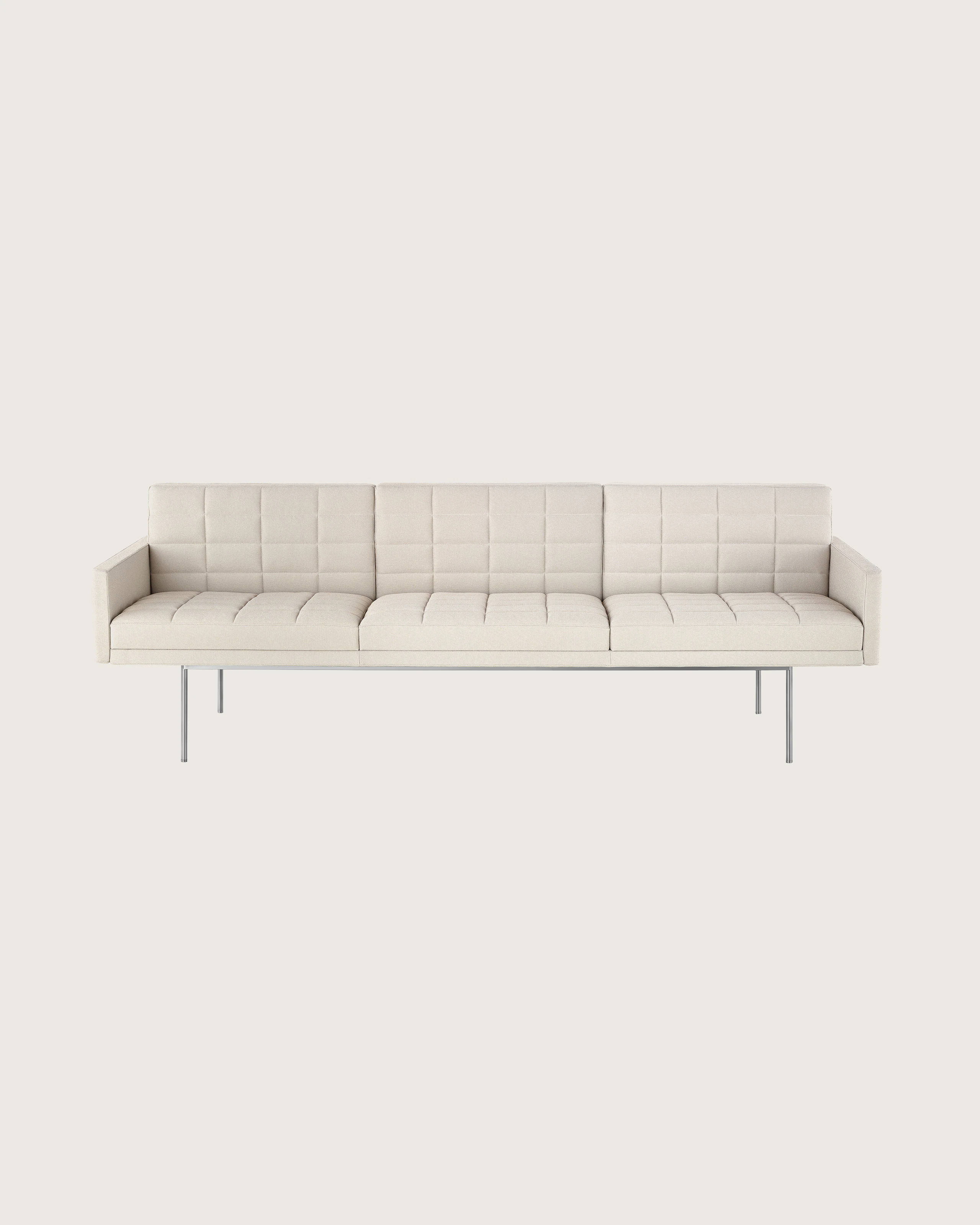 Partial front view of an ivory-colored Tuxedo Component sofa, showing the optional quilted upholstery.