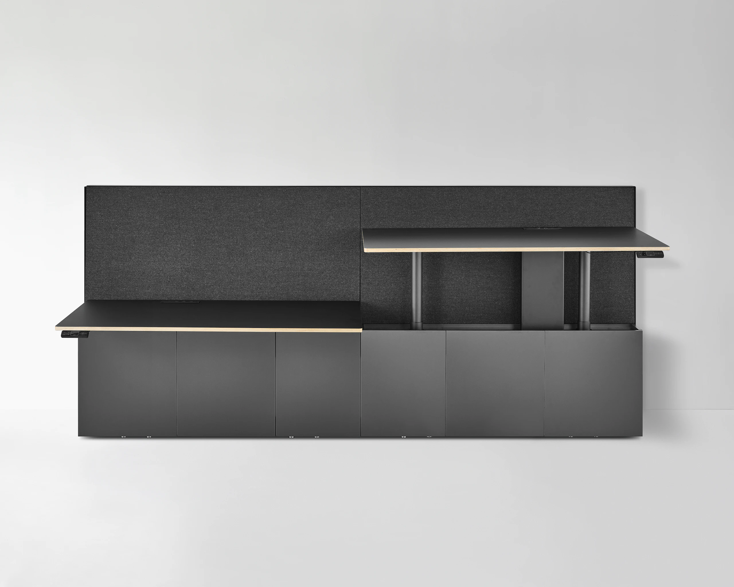 A Geiger One Casegoods bench system with one workstation at standing height and the other at sitting height.