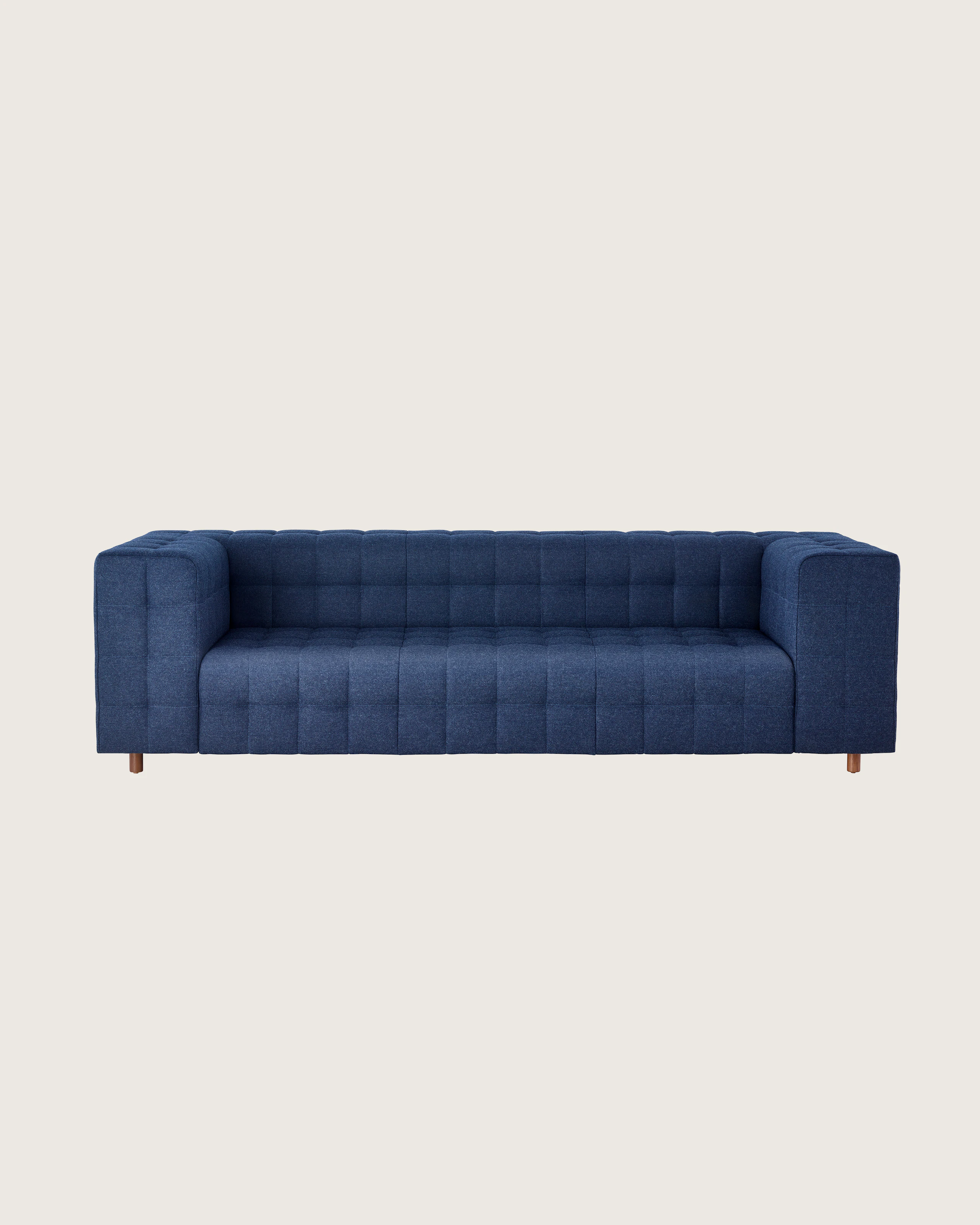 A three-seat Rapport Sofa in a deep navy colored textile, viewed from the front.