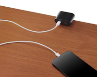 Clamp on USB-C power solution shown in black charging a phone.