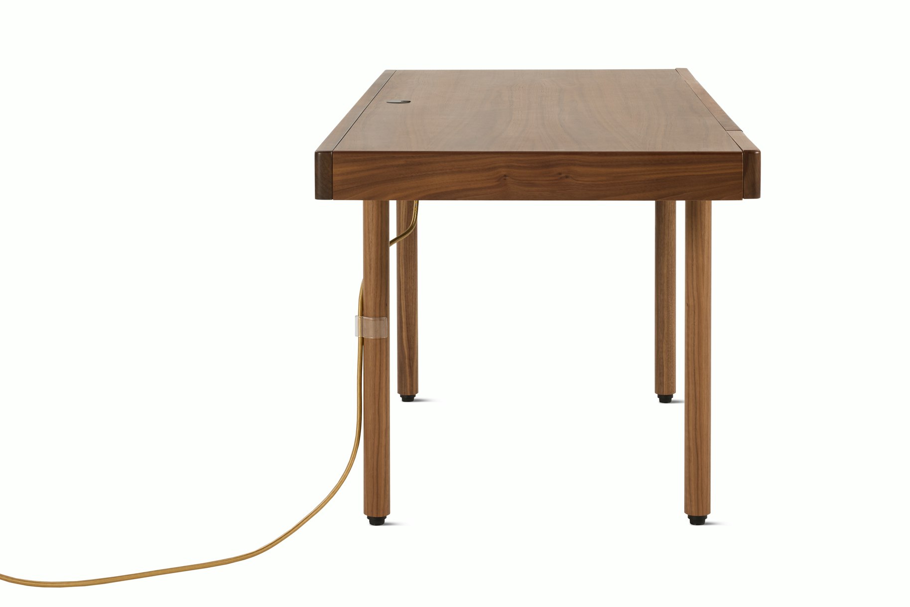 A New Canaan Wood Sit-to-Stand Desk in Walnut viewed from the side.