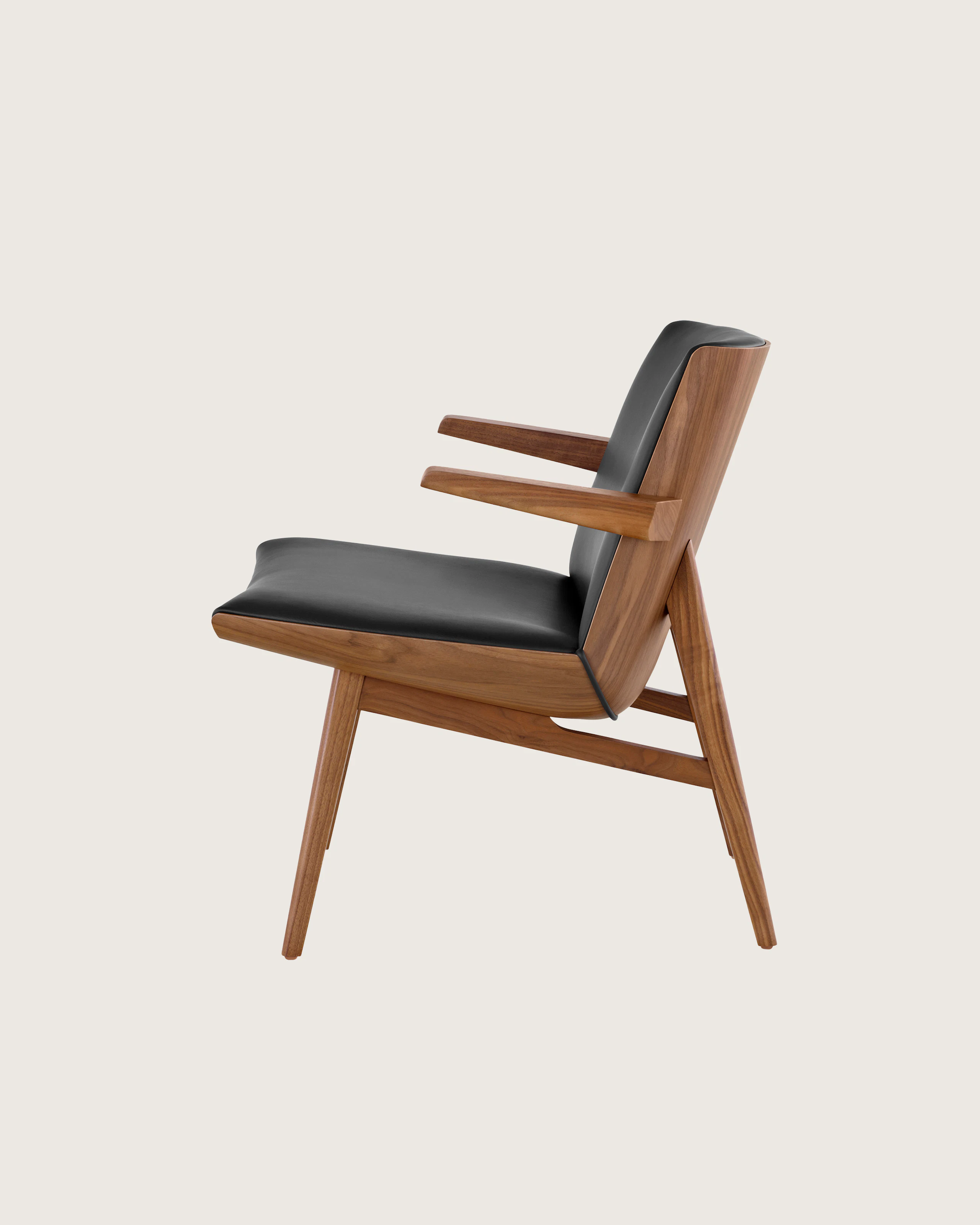 Side view of a low-back Clamshell Lounge Chair with black leather and walnut legs.