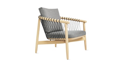 A side view of a Crosshatch Chair by Geiger with a natural wood frame and grey seat back and cushion