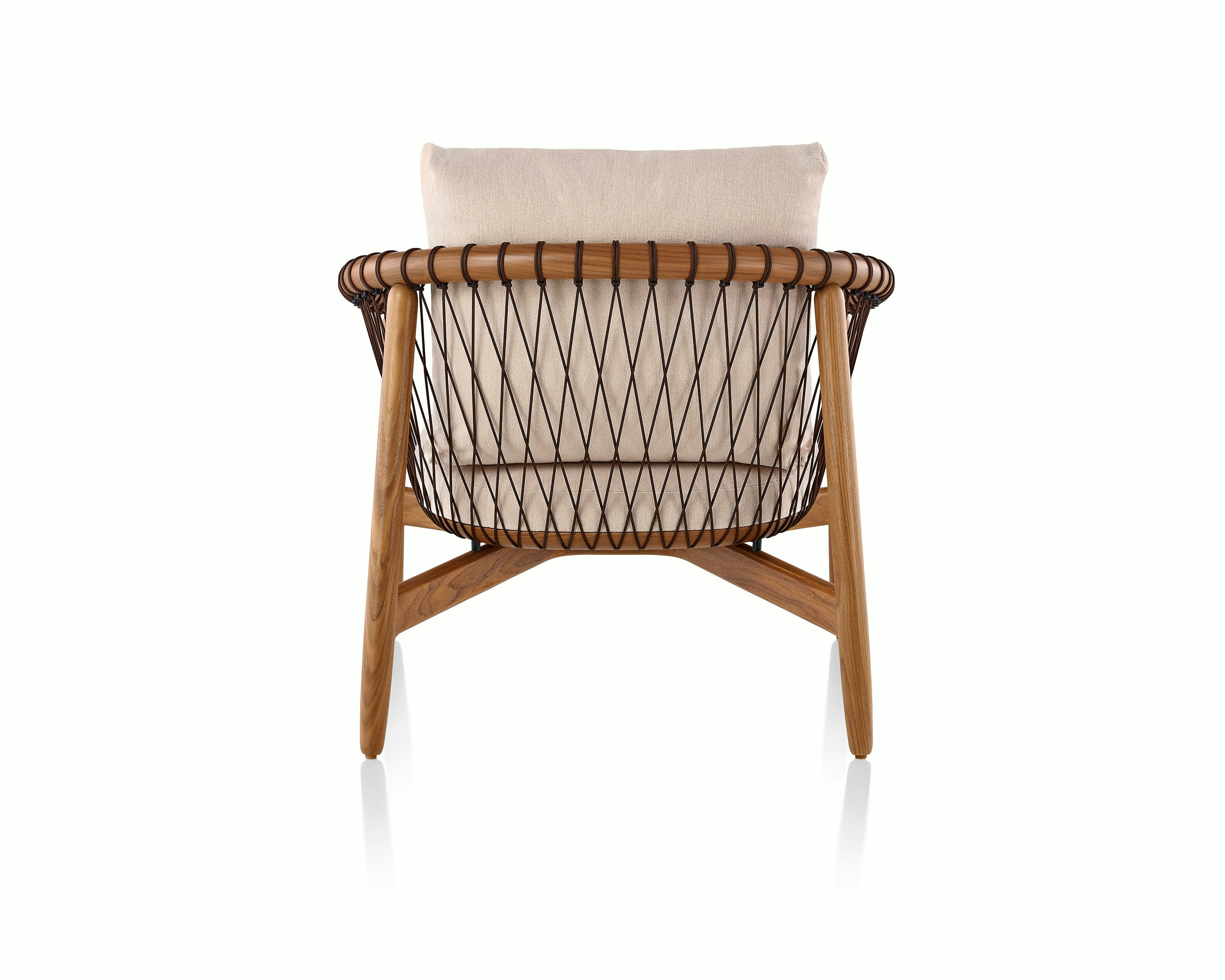 A Crosshatch lounge chair with linen-colored fabric and a wood frame in a medium finish, viewed from behind.