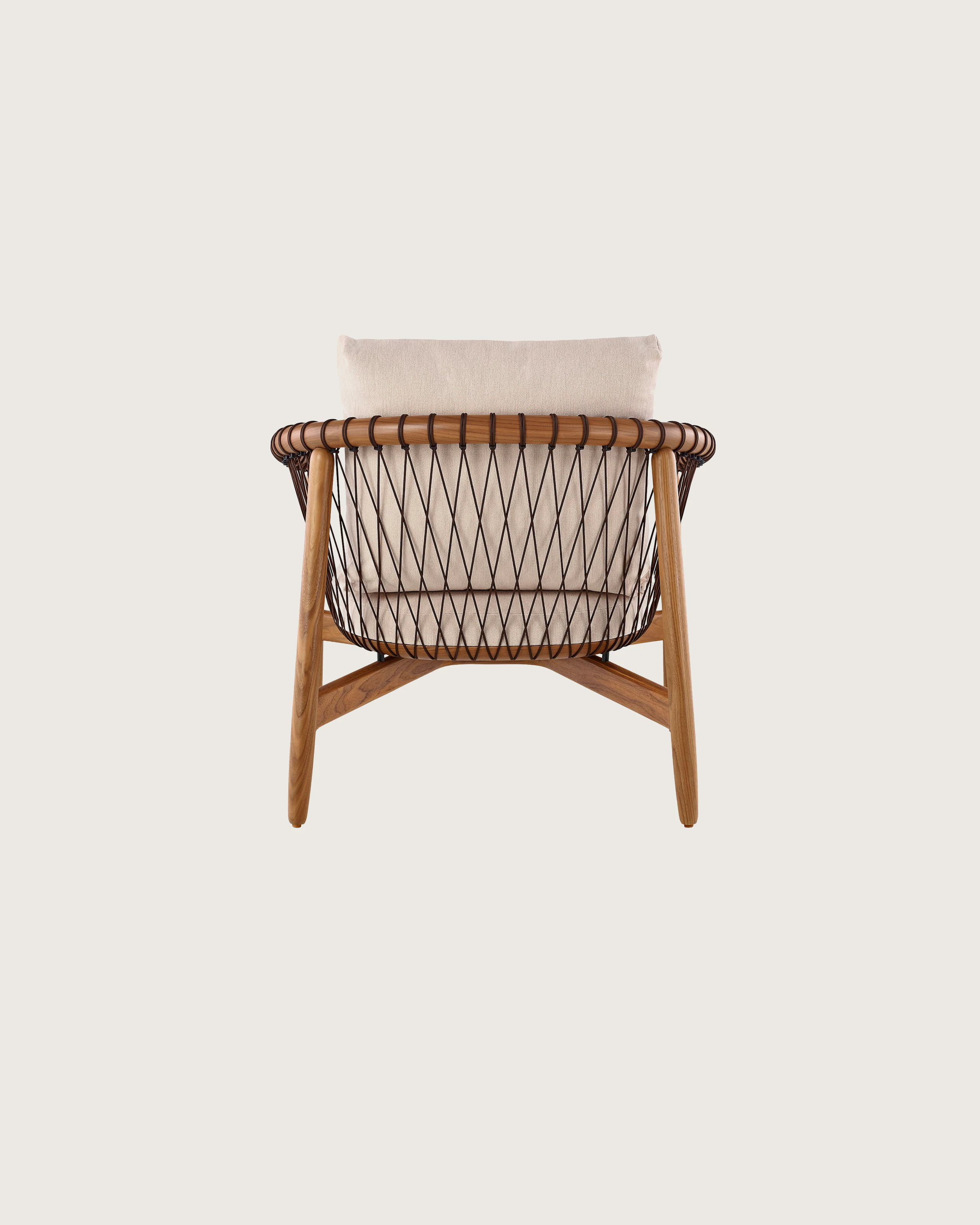A Crosshatch lounge chair with linen-colored fabric and a wood frame in a medium finish, viewed from behind.