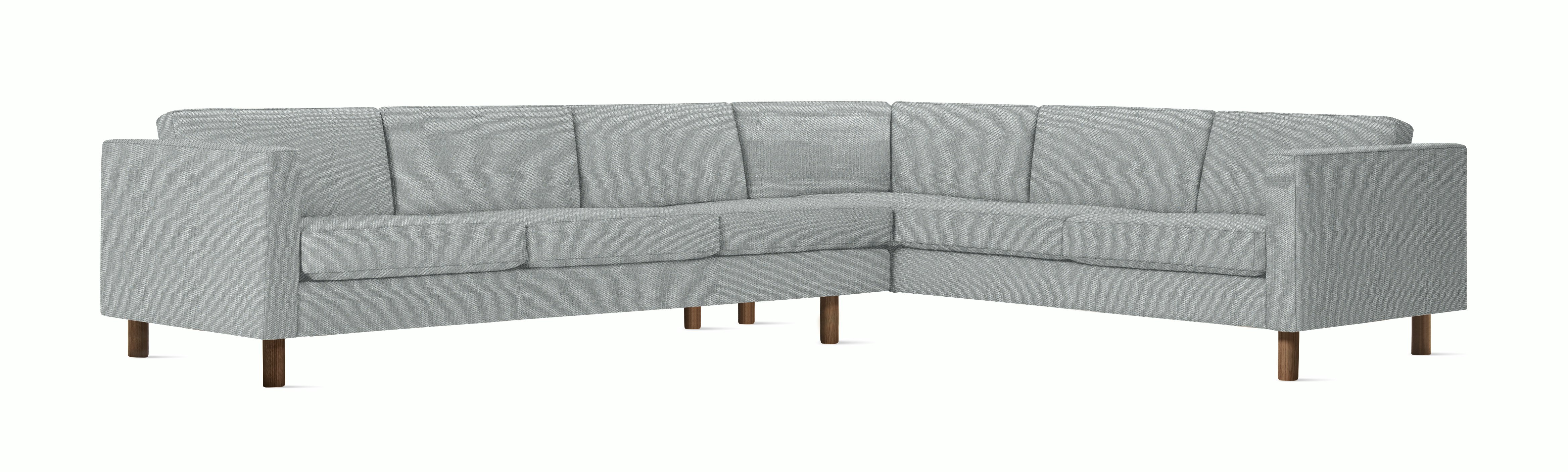 A Lispenard Corner Sectional in Powder with Walnut finish viewed from the front.