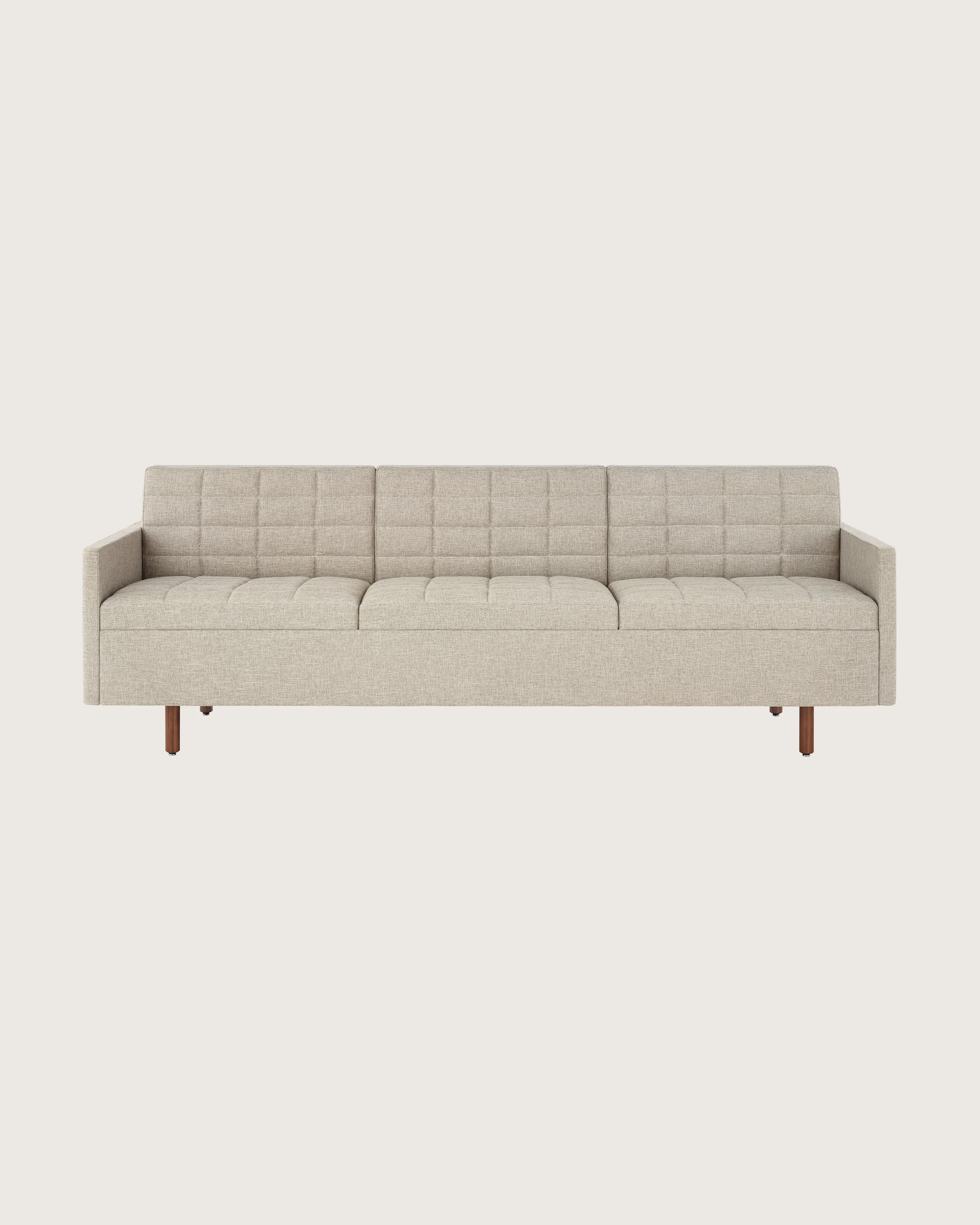 A Tuxedo Classic sofa with bone-colored quilted upholstery, viewed from the front.