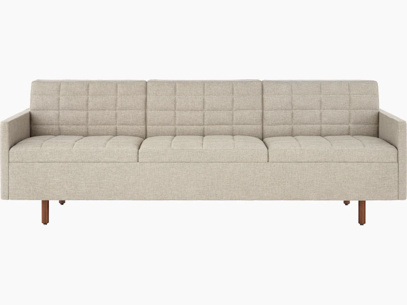 A Tuxedo Classic sofa with bone-colored quilted upholstery, viewed from the front.