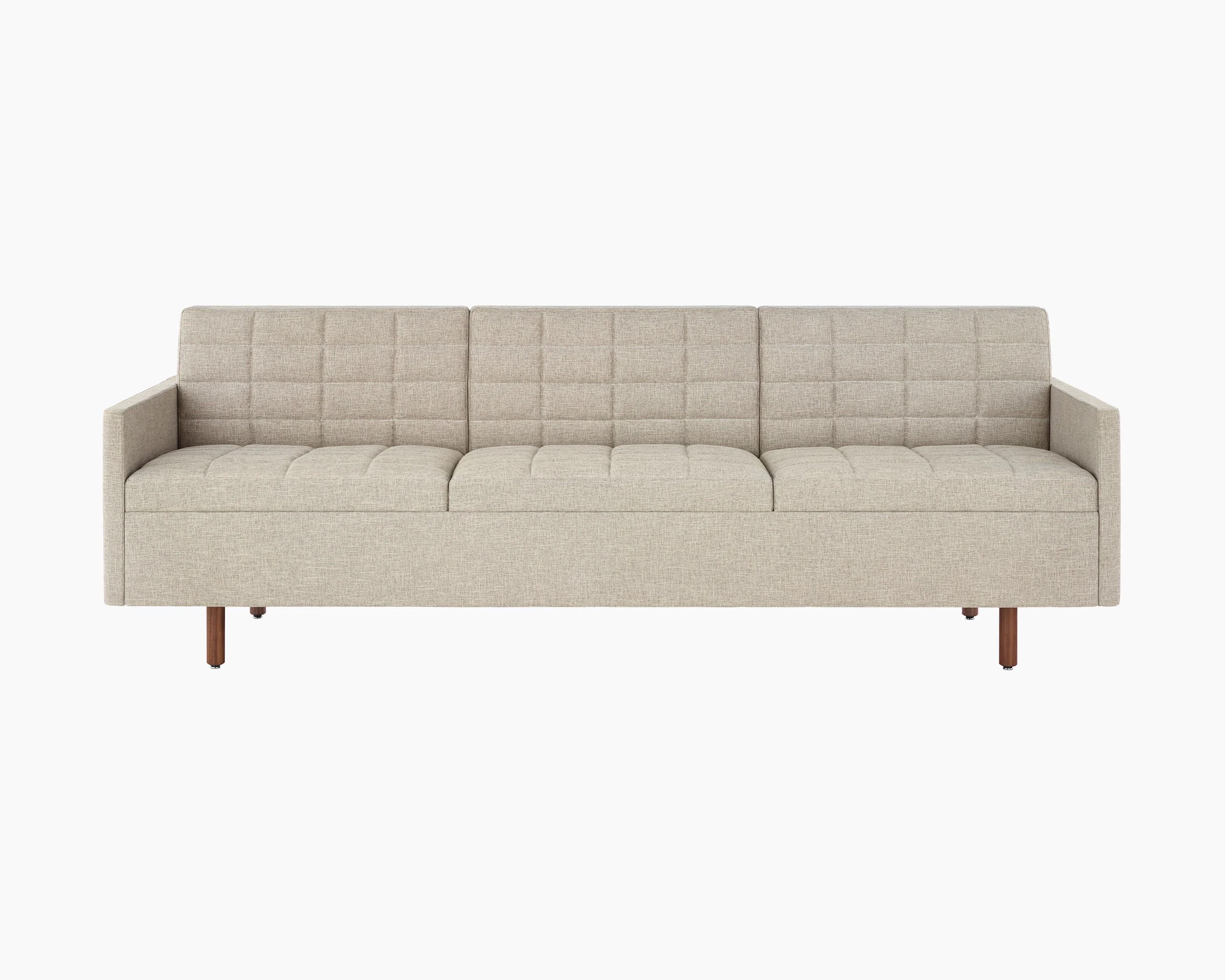 A Tuxedo Classic sofa with bone-colored quilted upholstery, viewed from the front.