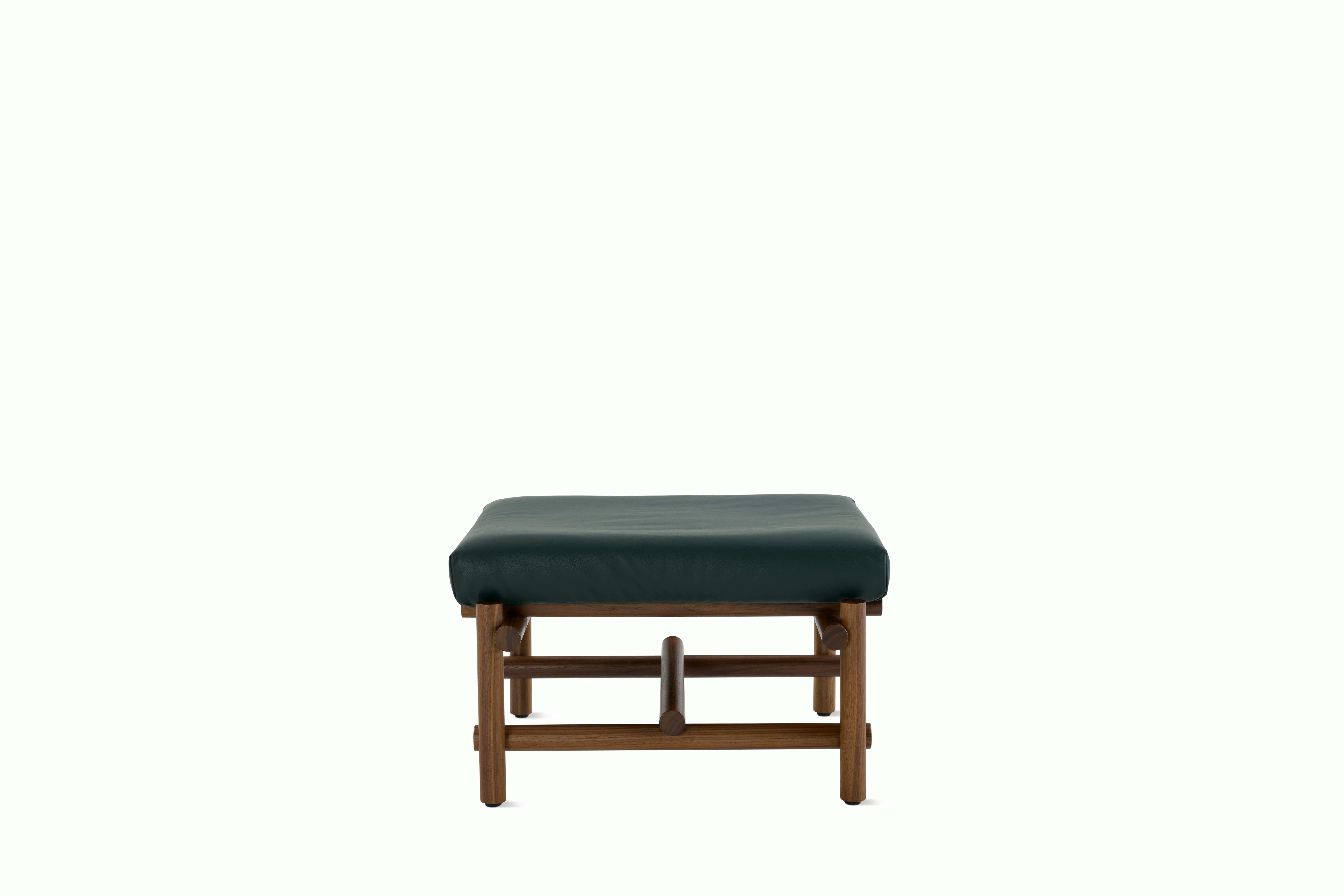A Muecke Ottoman in Forest Green Walnut viewed from the front.