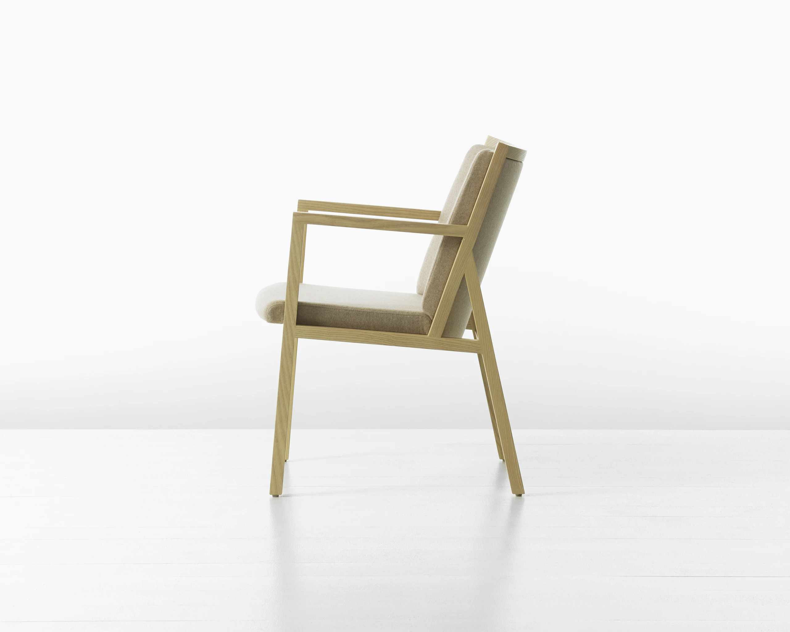 A Ascribe Chair upholstered in Clare Bluff textile, viewed from the side.