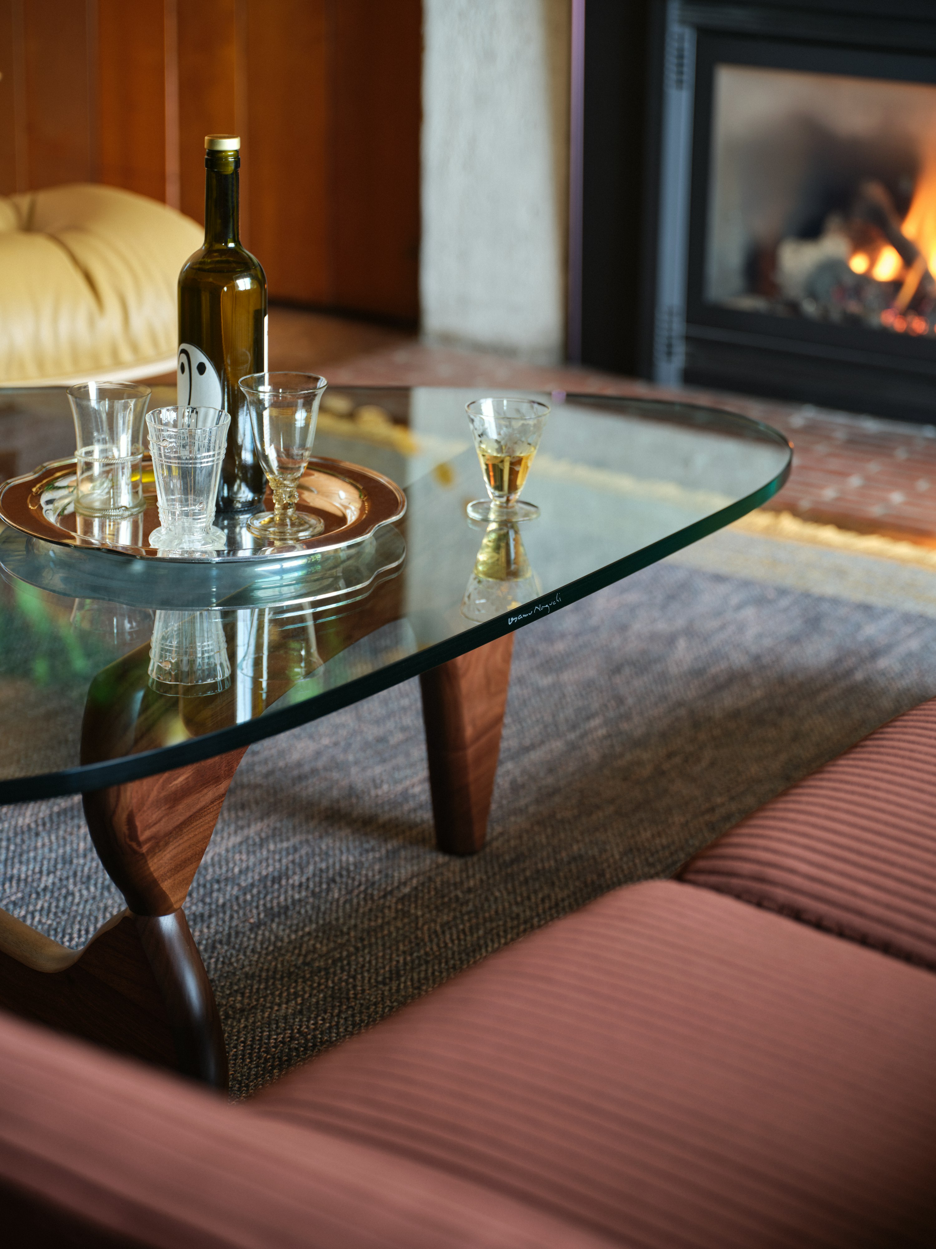 Noguchi Table in Walnut with cocktails and a fire