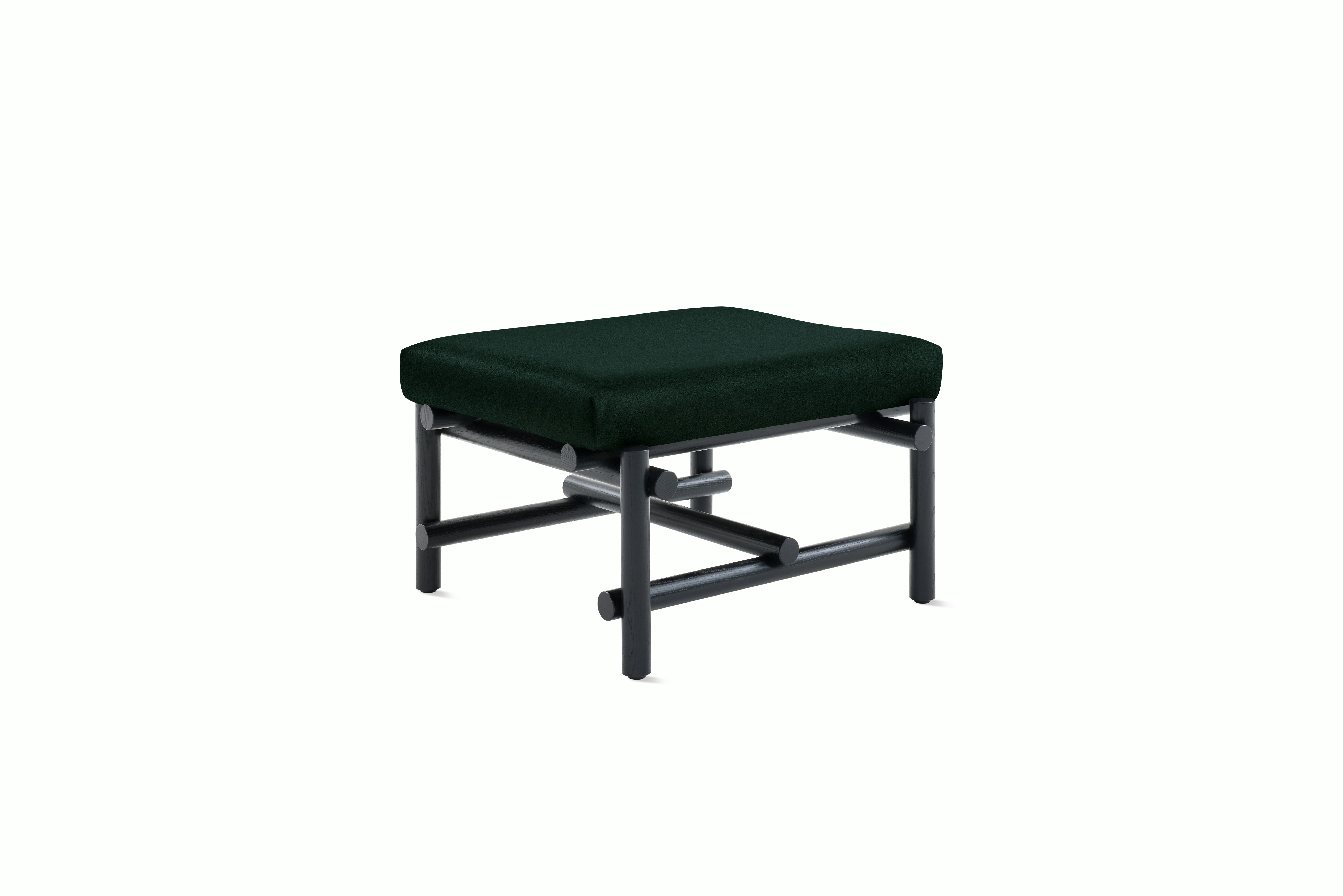 A Muecke Ottoman in Dark Green Ebonized Ash viewed from an angle.
