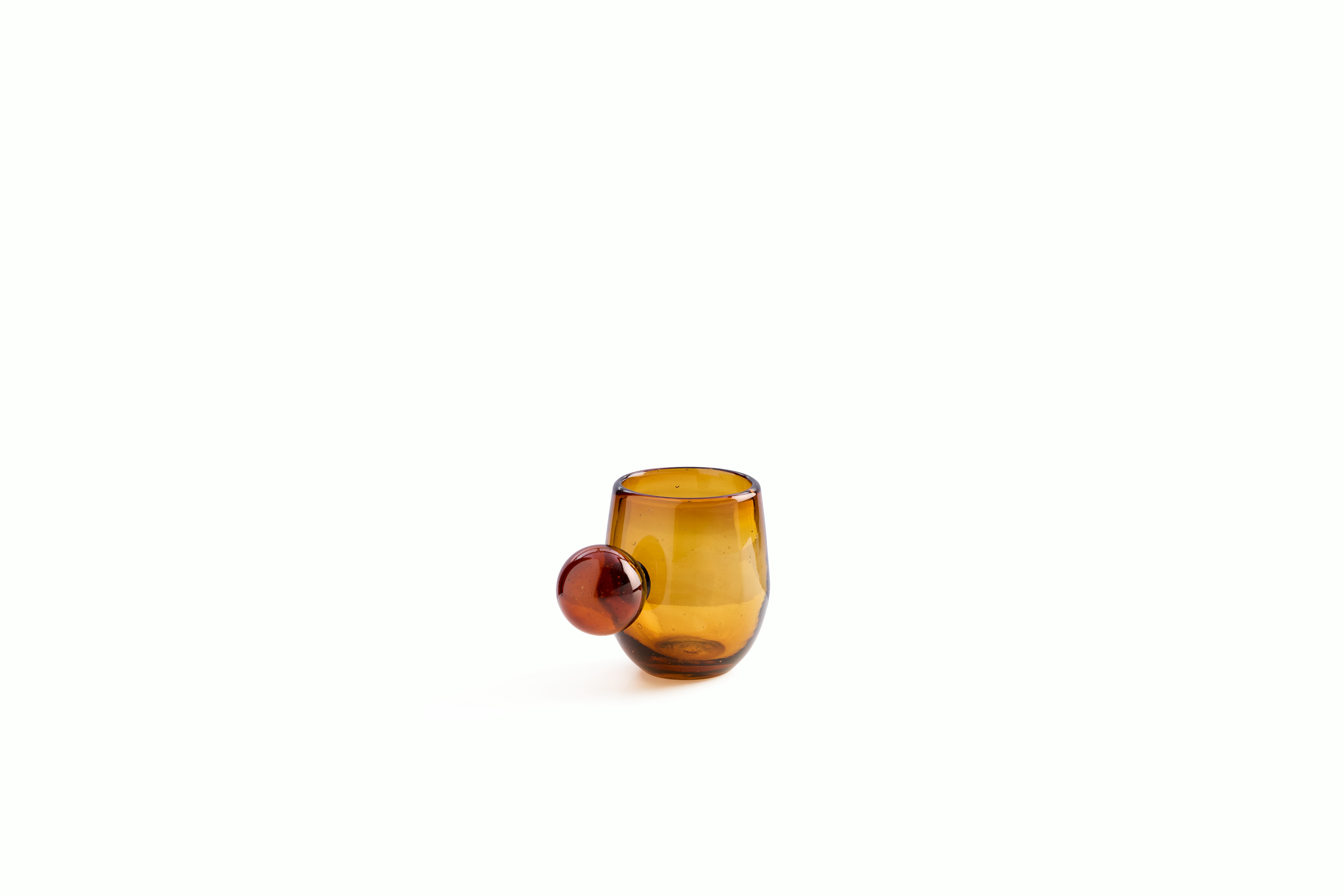 A Roo Glasses, Set of 4 in Amber viewed from an angle.