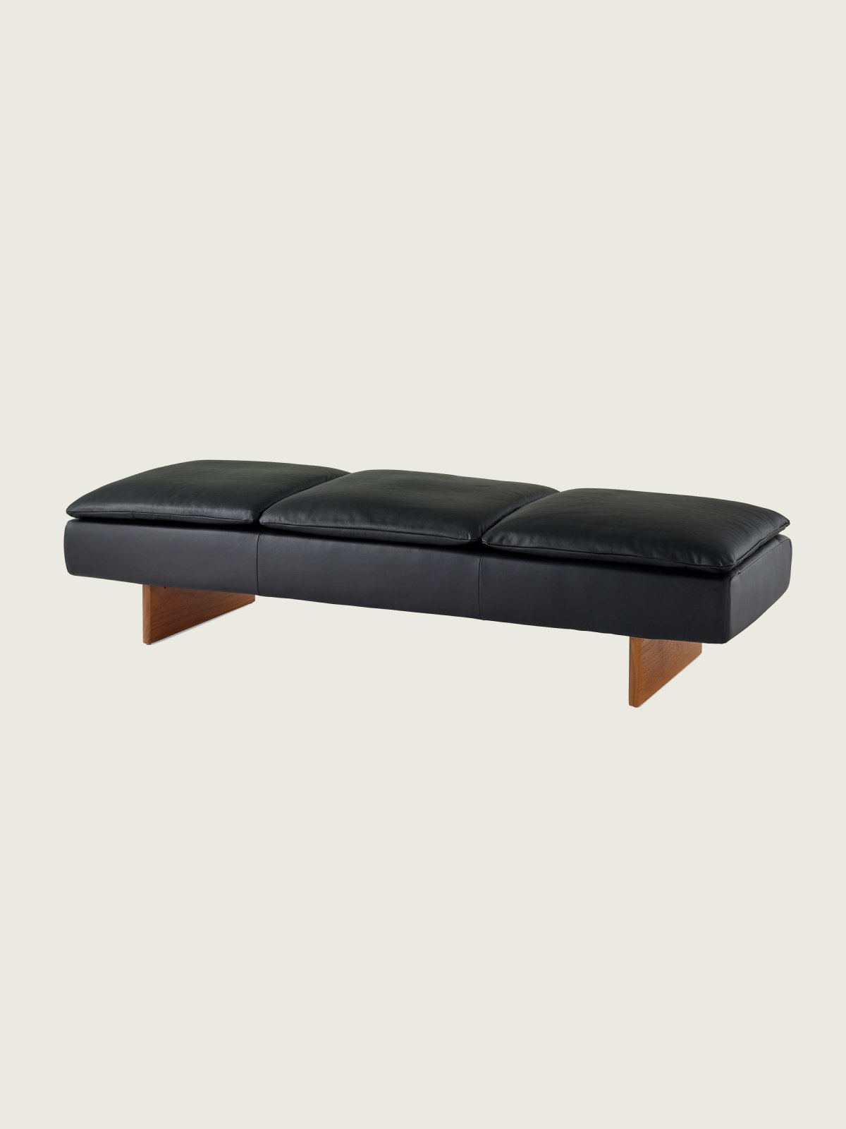 Mantle Three Seater Bench in black leather with a walnut base, viewed at an angle.