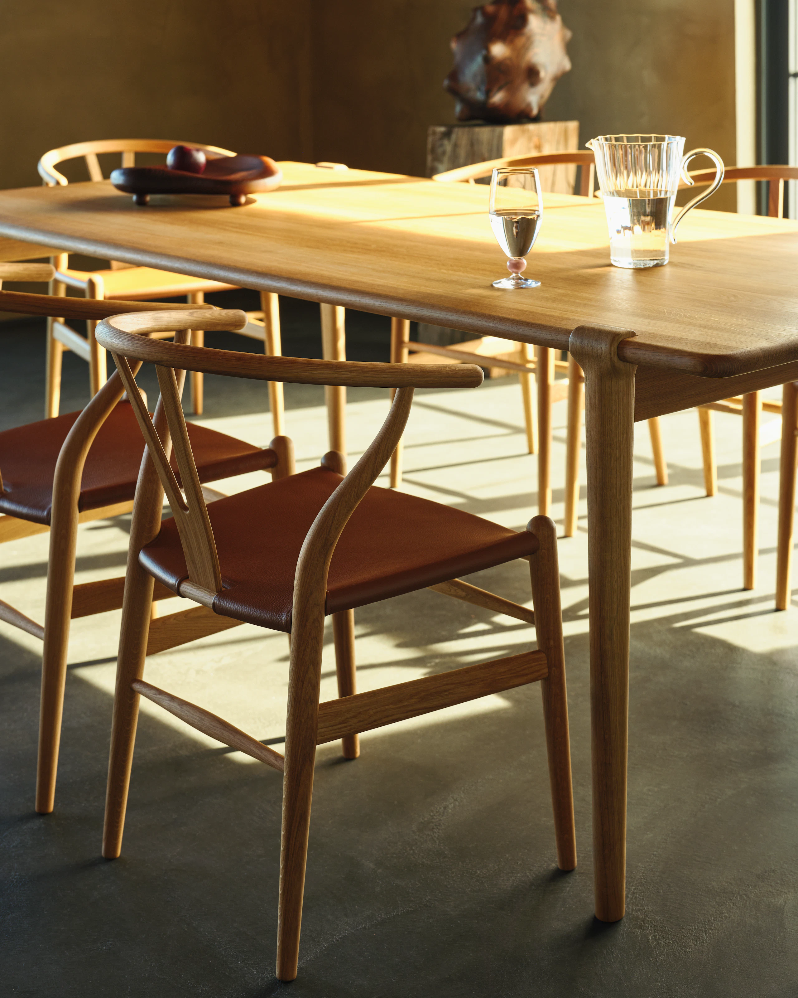 Wishbone Chair in Oak with Dark Brown Leather Seat at Otto Dining Table.