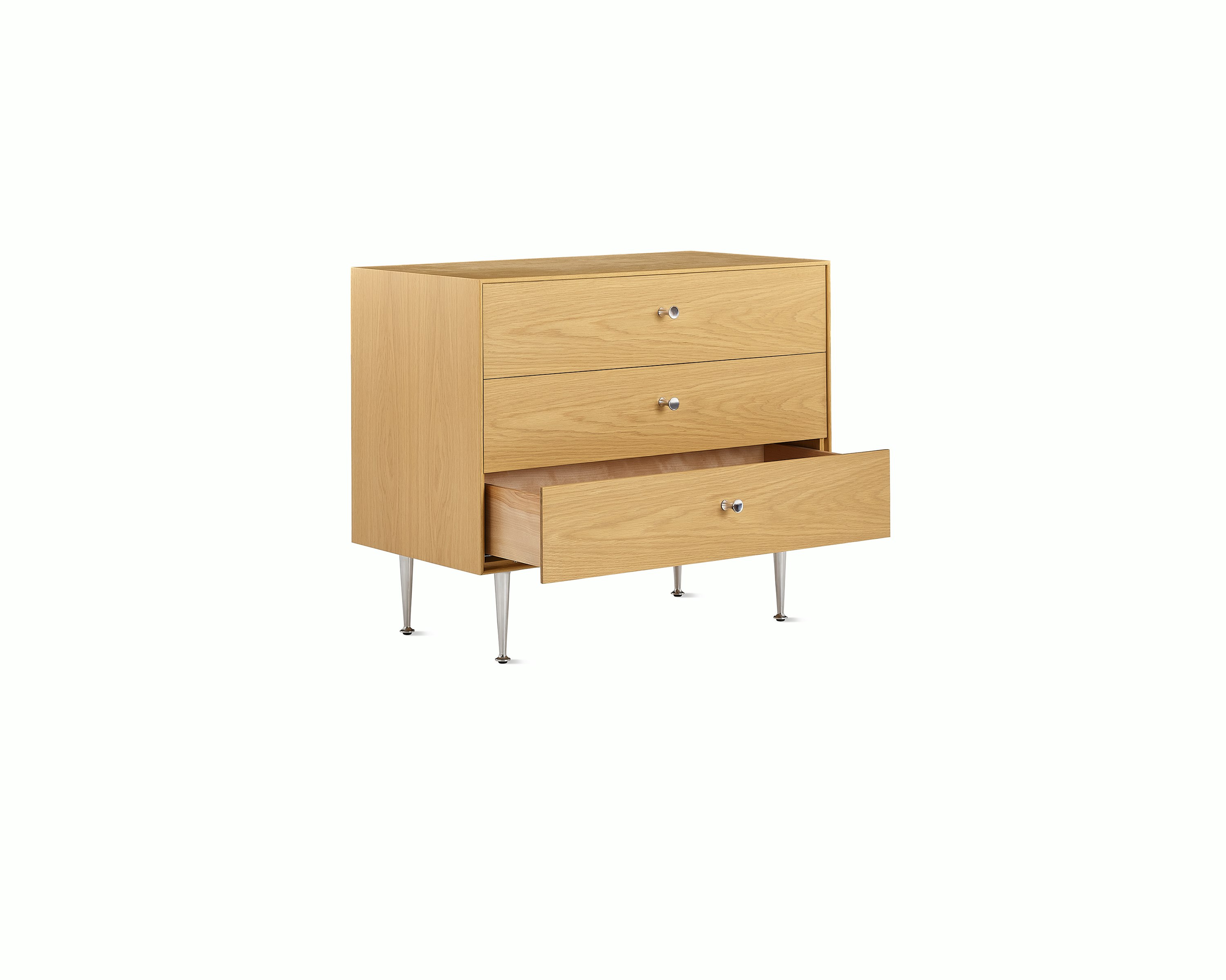 Light brown Nelson Thin Edge Chest with one drawer open, viewed from an angle.