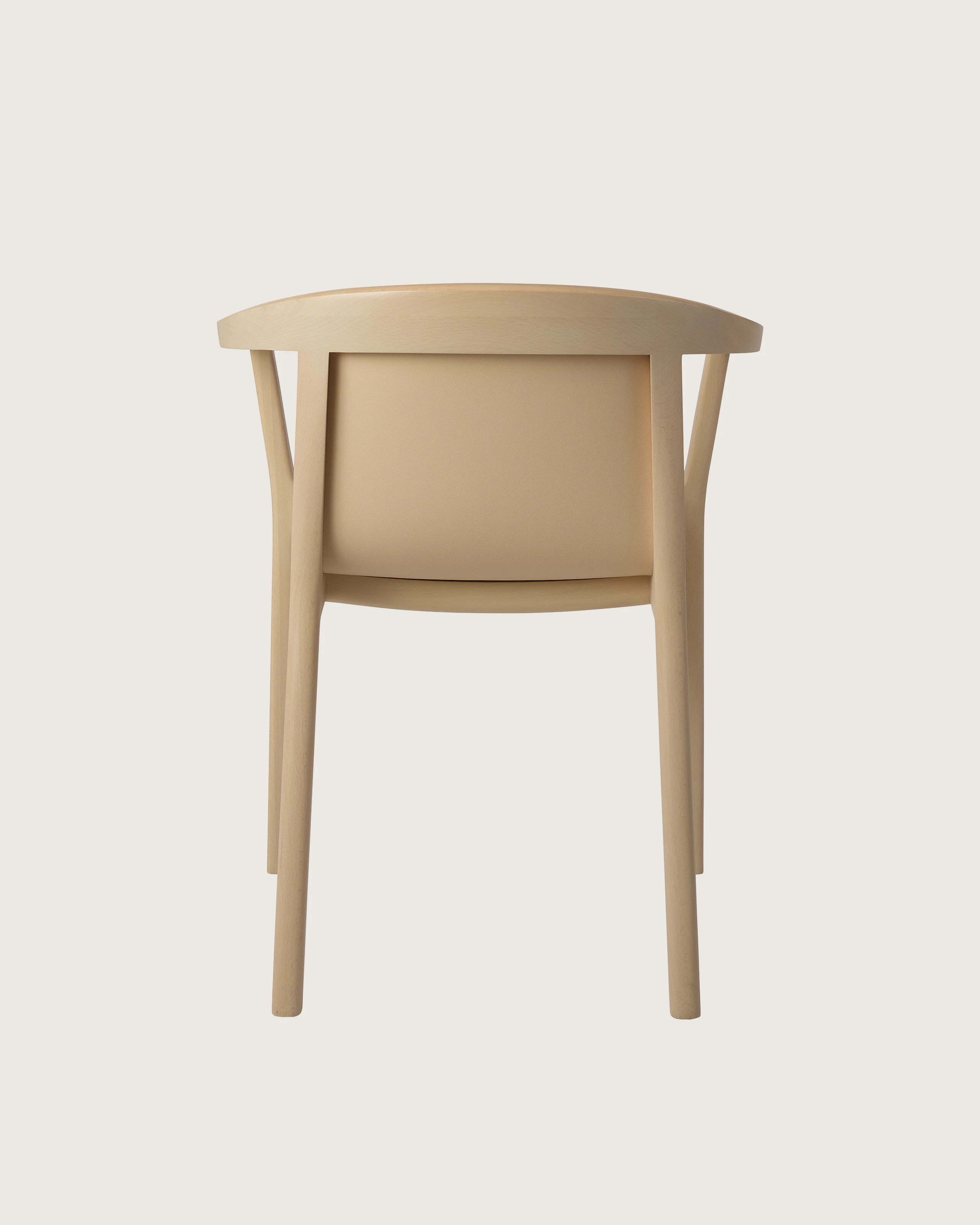 Lijn Armchair by Carole Baijings for Geiger in Light Beech frame upholstered with Maharam Prone Leather in Balsa, back view on a white sweep.
