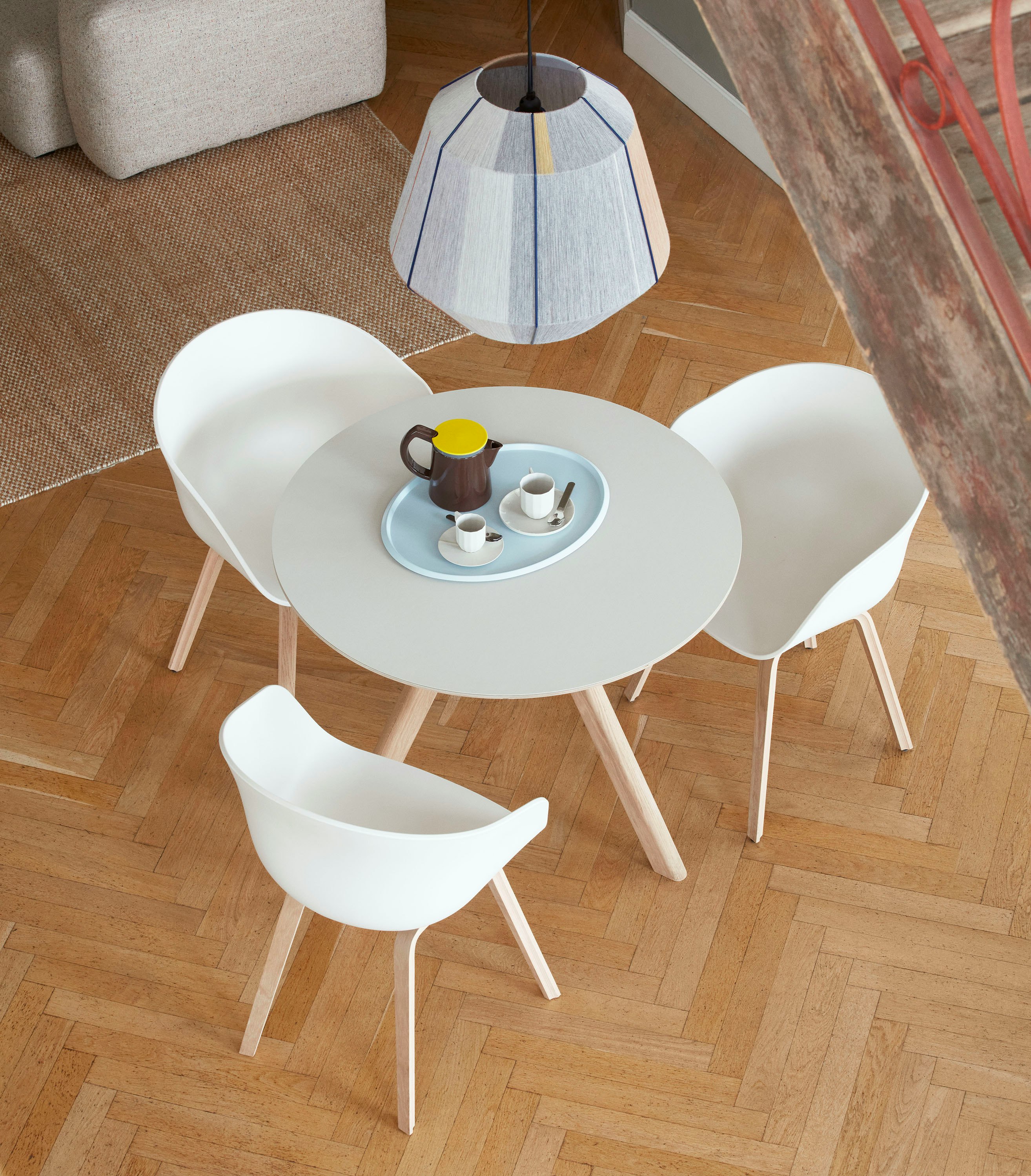 A Copenhague 20 Dining Table surrounded by About A Chairs.