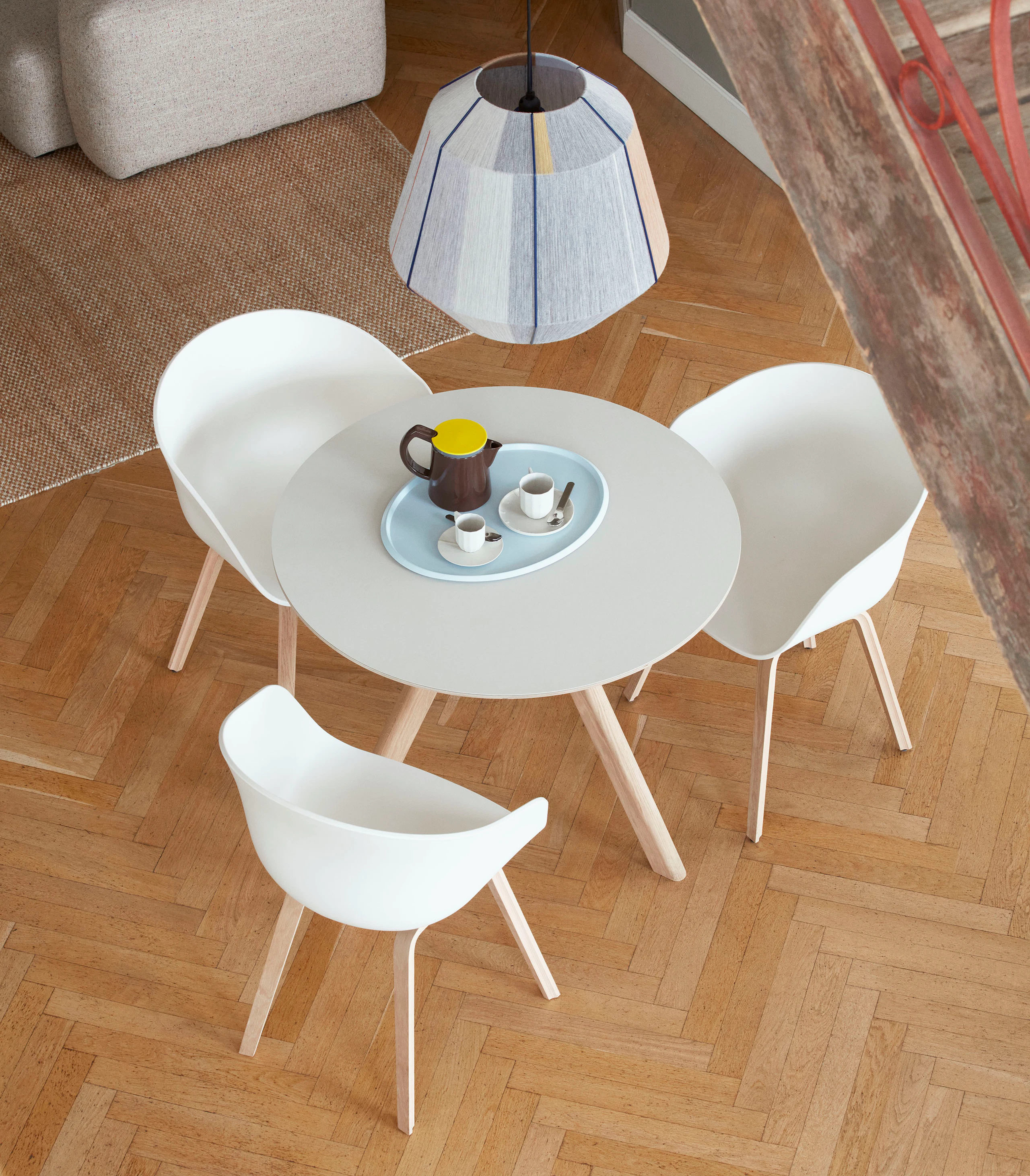 A Copenhague 20 Dining Table surrounded by About A Chairs.