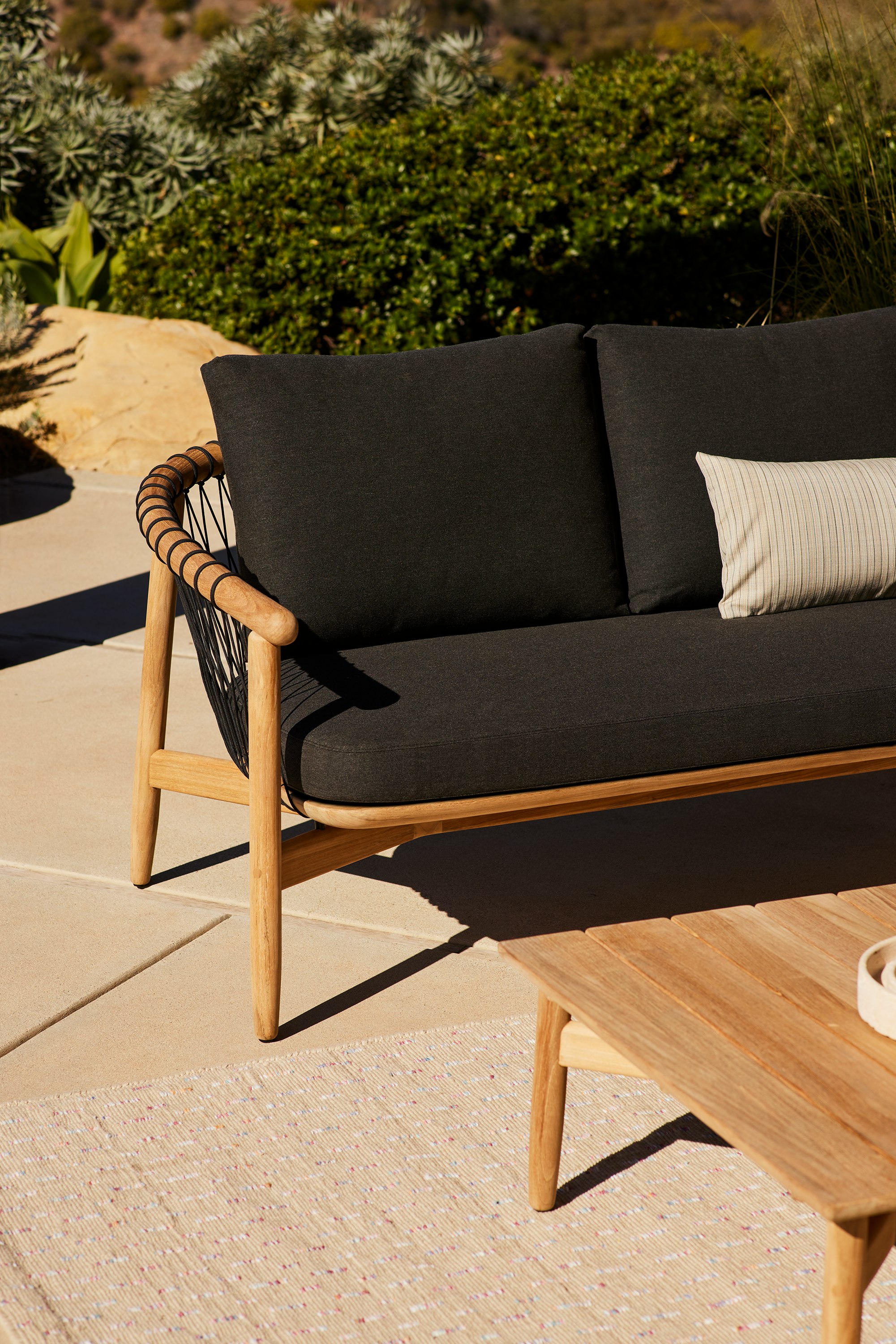 Crosshatch Outdoor Settee and Coffee Table in an environmental setting.