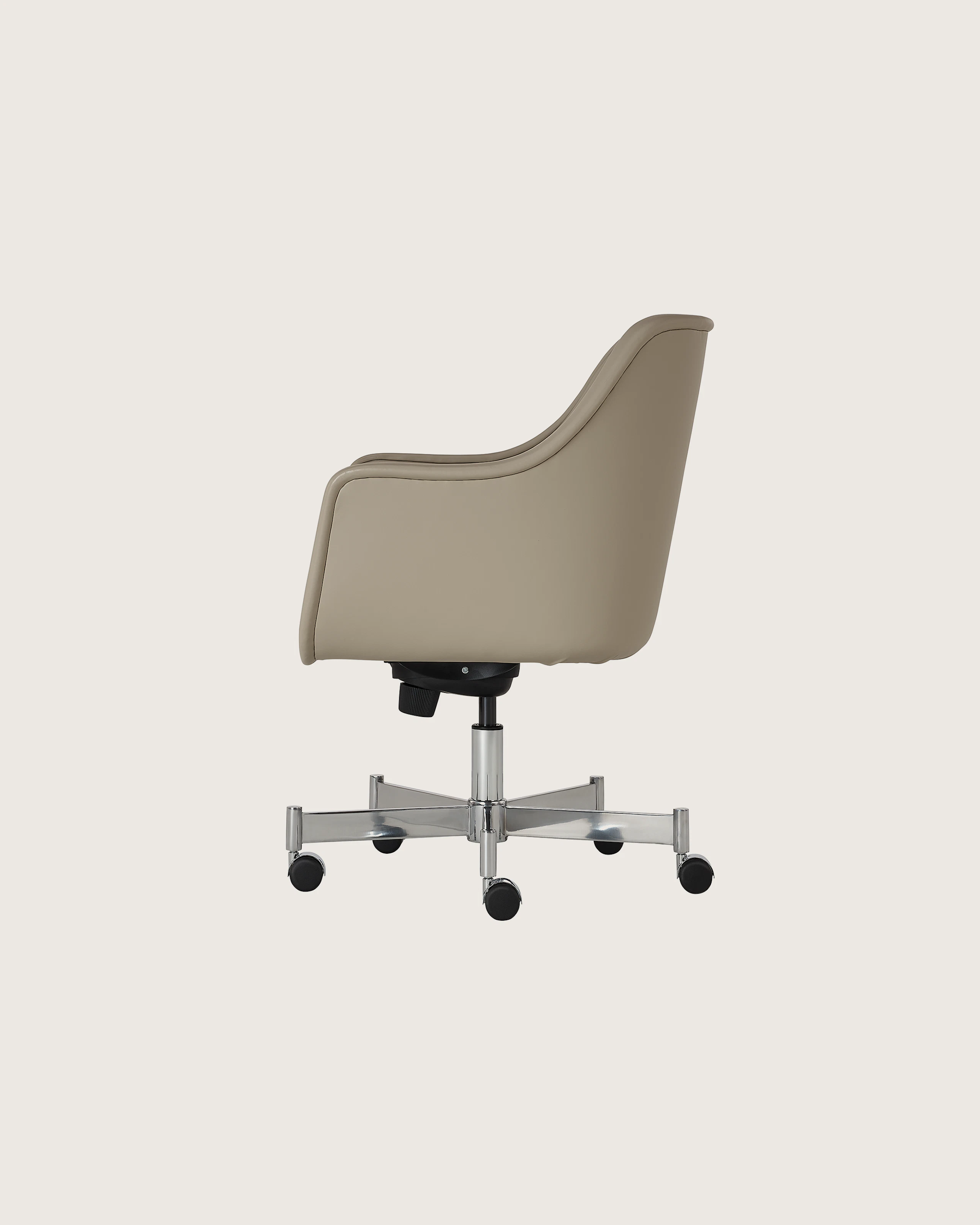Bumper Conference Chair designed by Ward Bennett upholstered in Pace Leather in Reflection with a polished chrome base, shown in profile on a white sweep.