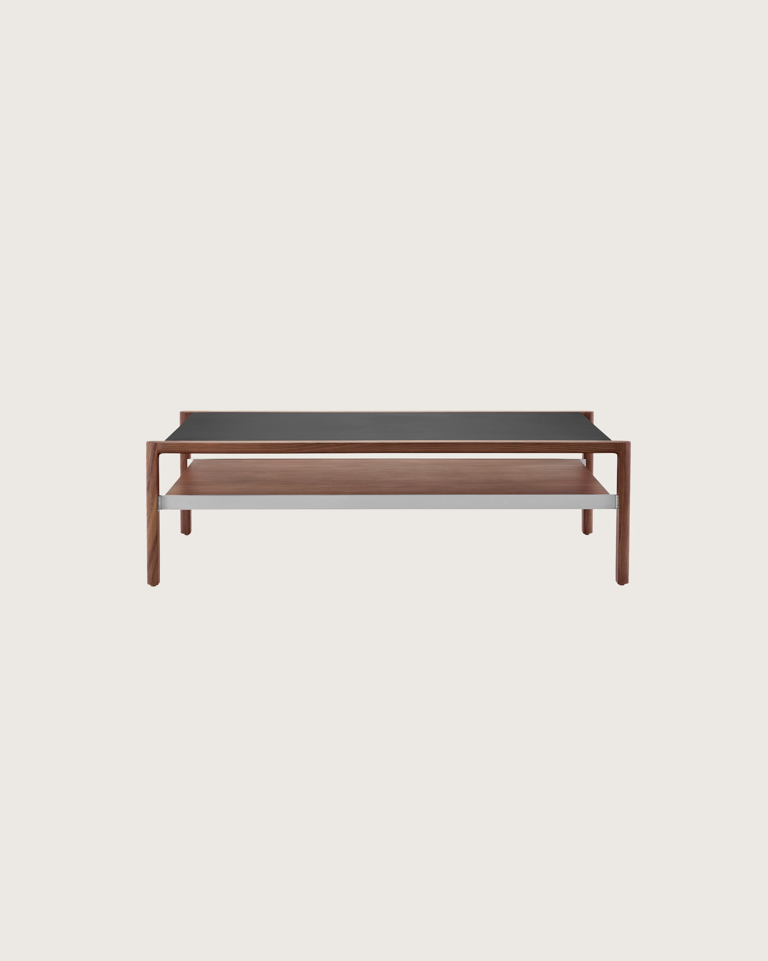 Partial front view of a rectangular Brabo coffee table with a black Bristol Leather-wrapped top, walnut lower shelf, and metal frame supports.