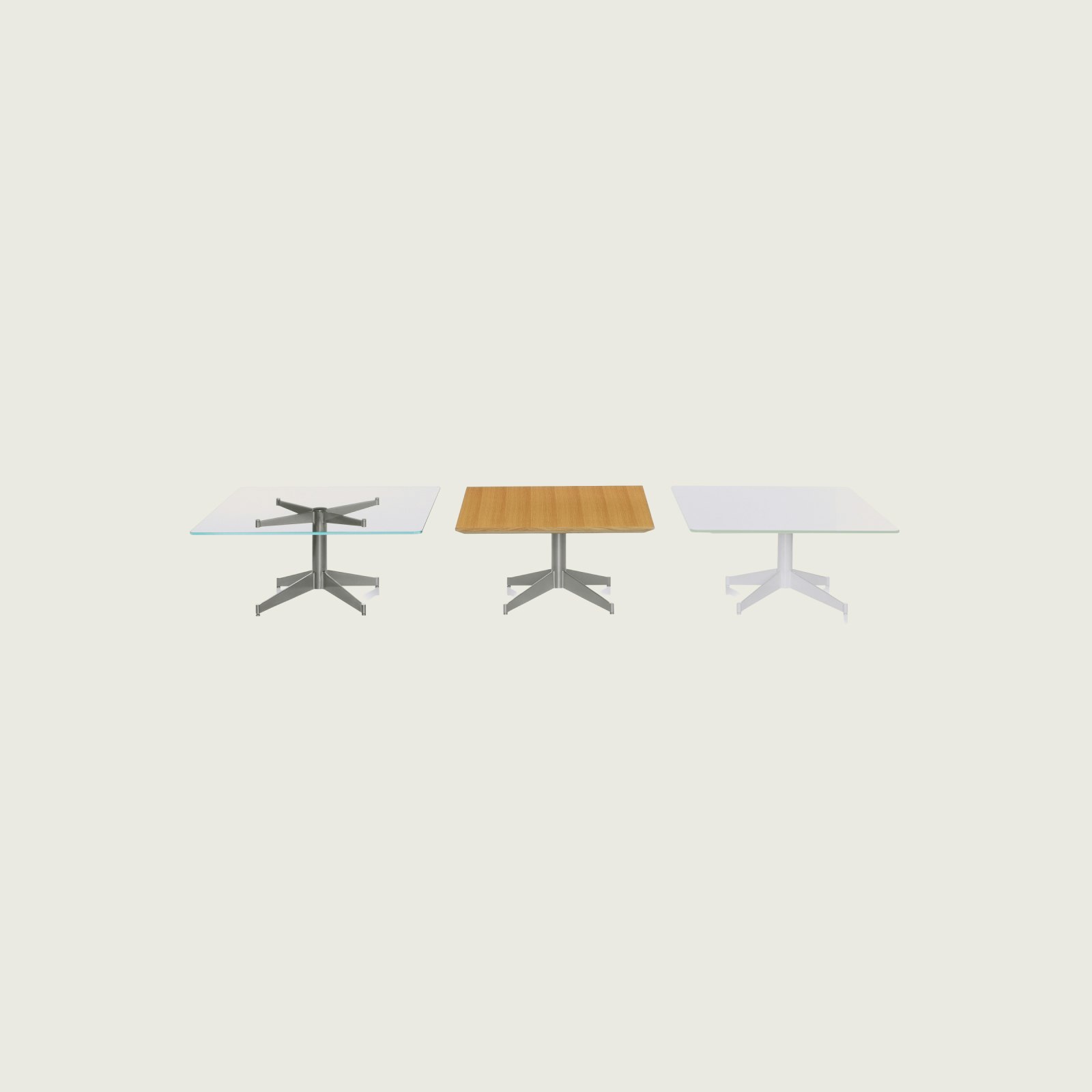 Three MP Tables arranged against a white background. Each table has a different top and base finish, but are all rectangular in shape.
