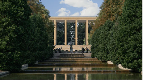 Exterior view of Cranbrook Academy of Art overlooking a multi-tiered fountain, statue, and trees.