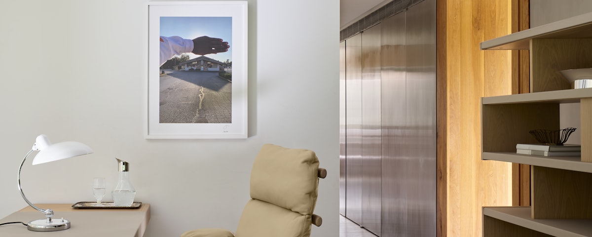 "Naptown Googie" photograph hanging on a wall behind a Ramus High Back Chair in a home office setting