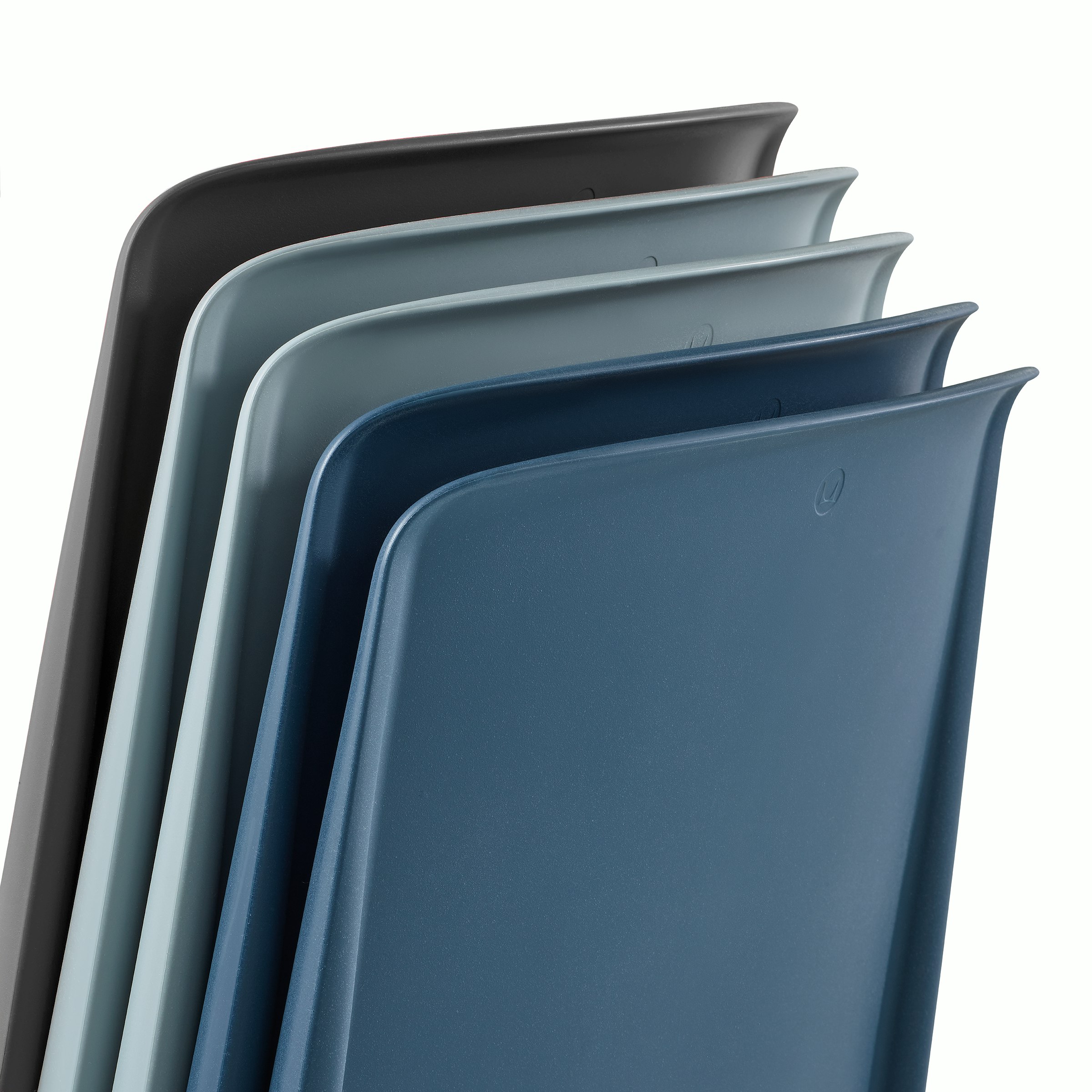 A detail photograph showing the back of 5 Pronta Stacking Chairs in black, glacier (light blue), and peacock (darker blue) colorways.