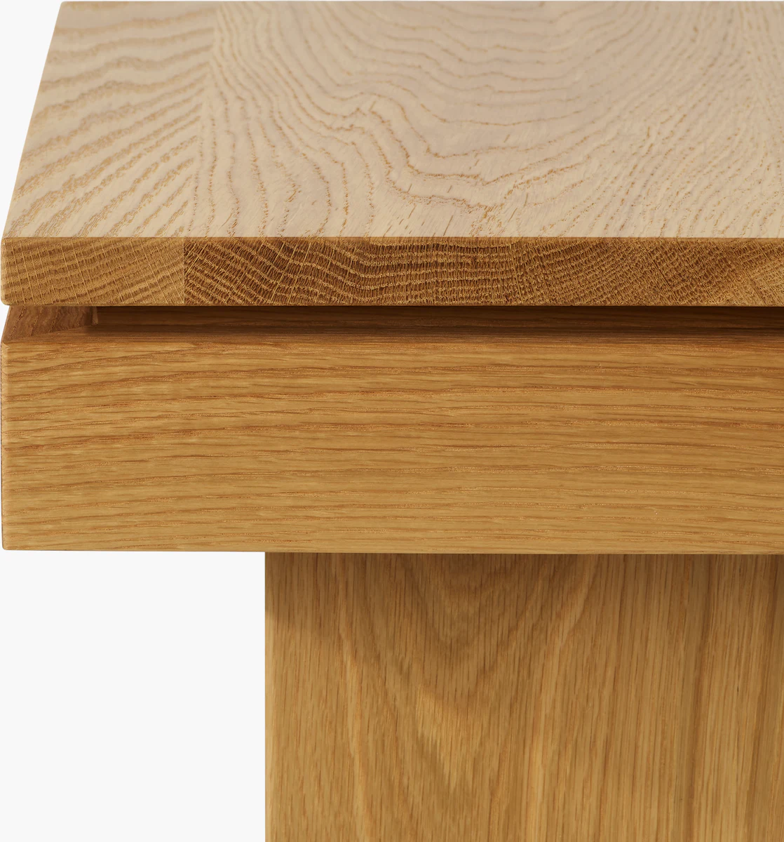 Close-up of wood grain and edge of a light oak coffee table
