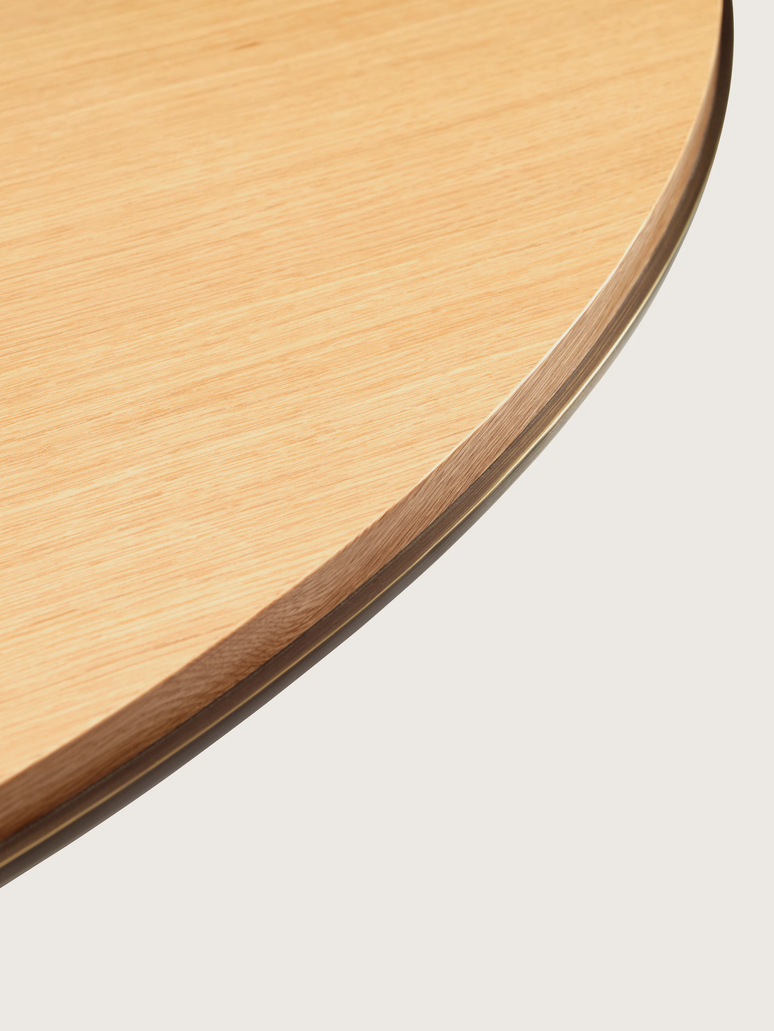 Highline Meeting Table with round Plain Sliced Maple top, Oil Rubbed Bronze Metal edge, detail view.