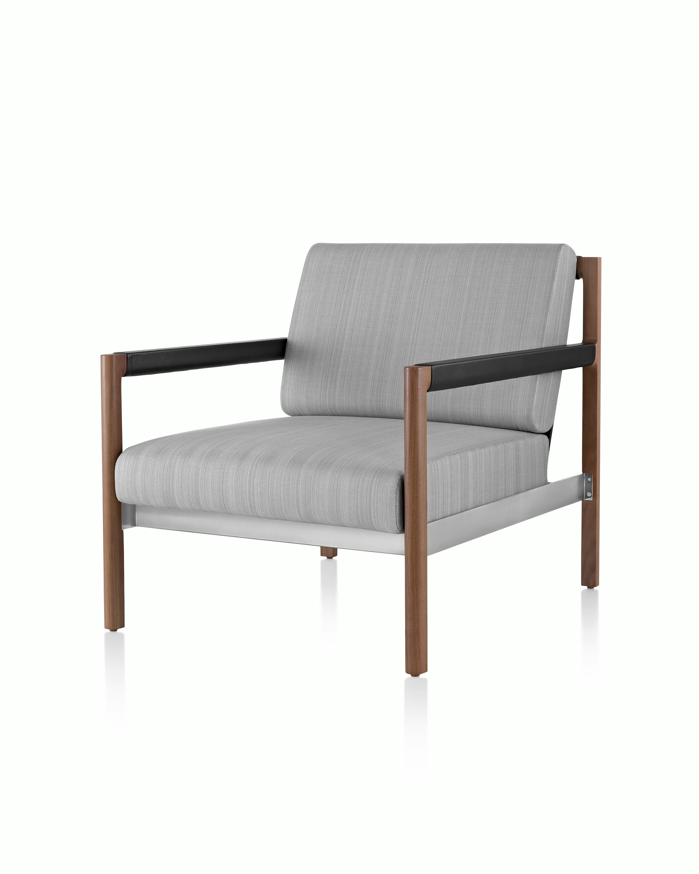 A Brabo Club Chair with light gray upholstery, leather and metal accents, and an exposed wood frame. Viewed at an angle.
