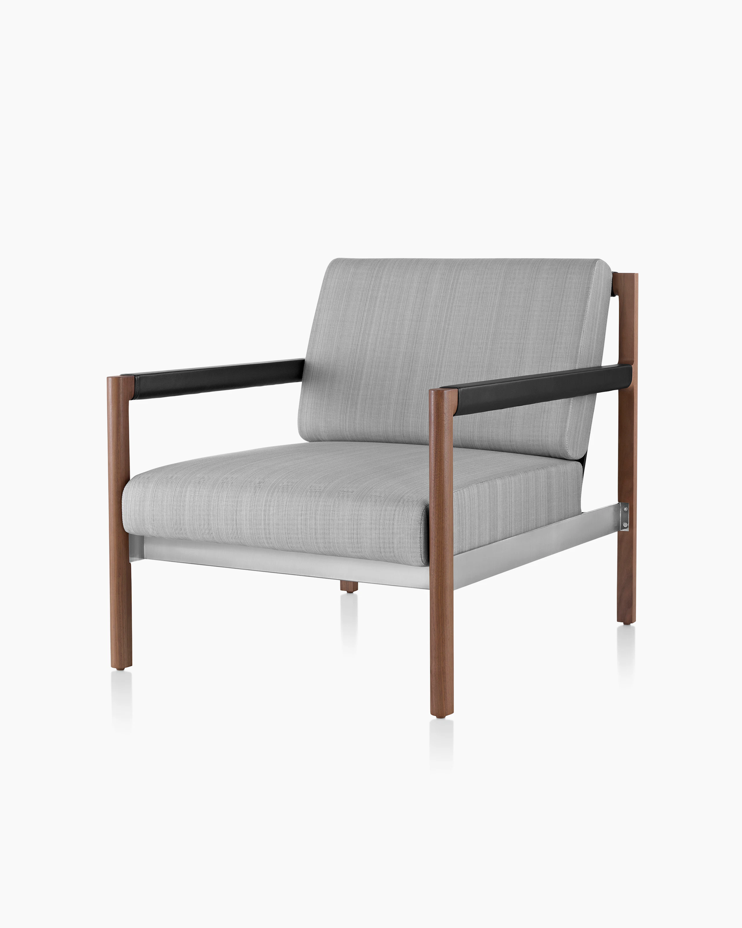 A Brabo Club Chair with light gray upholstery, leather and metal accents, and an exposed wood frame. Viewed at an angle.