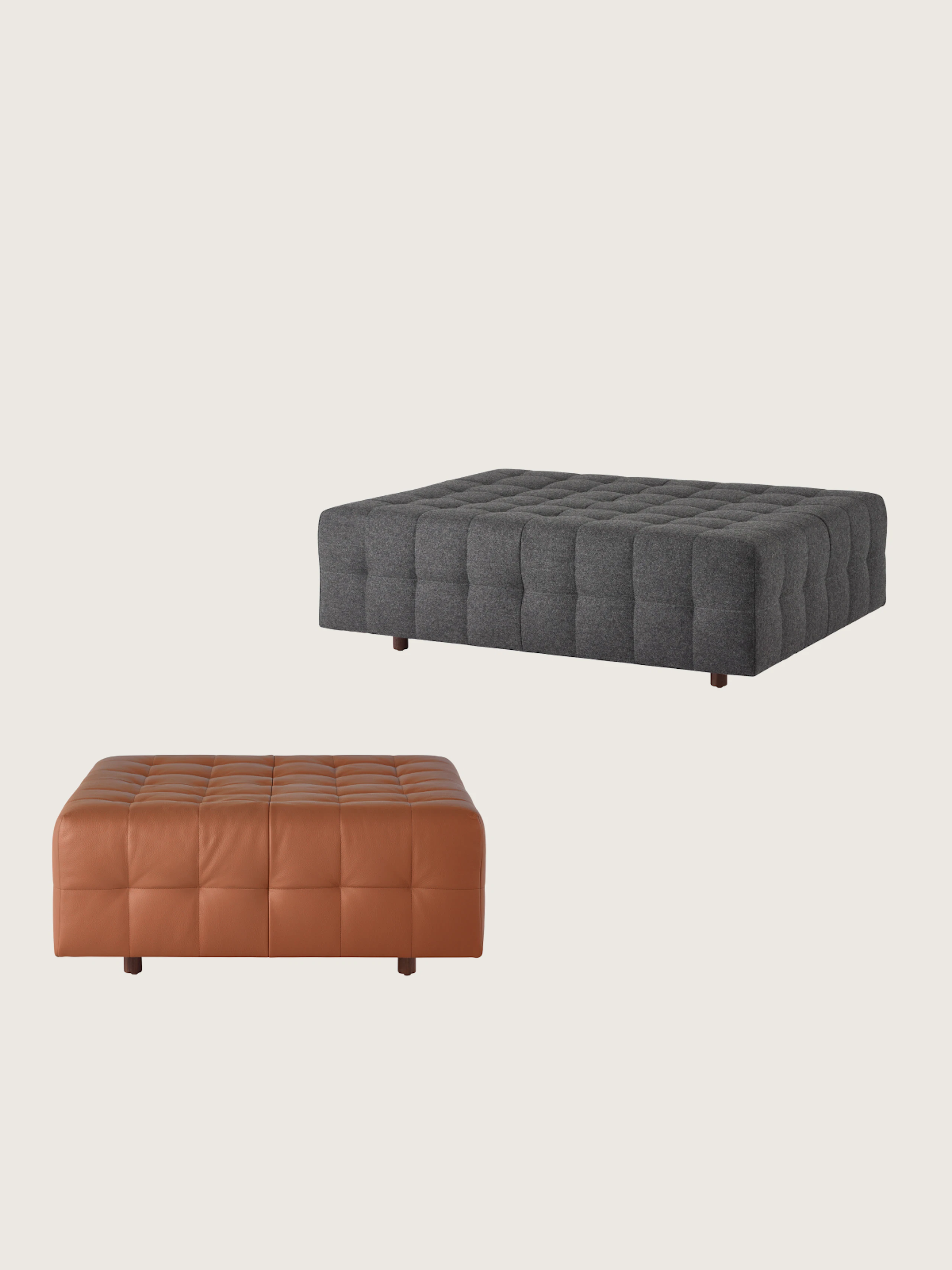 Two Rapport Ottomans designed by Isay Weinfeld, one front-facing small version upholstered with tan leather, one large version upholstered with a dark grey textile viewed at an angle and staggered above the other, on a white sweep.