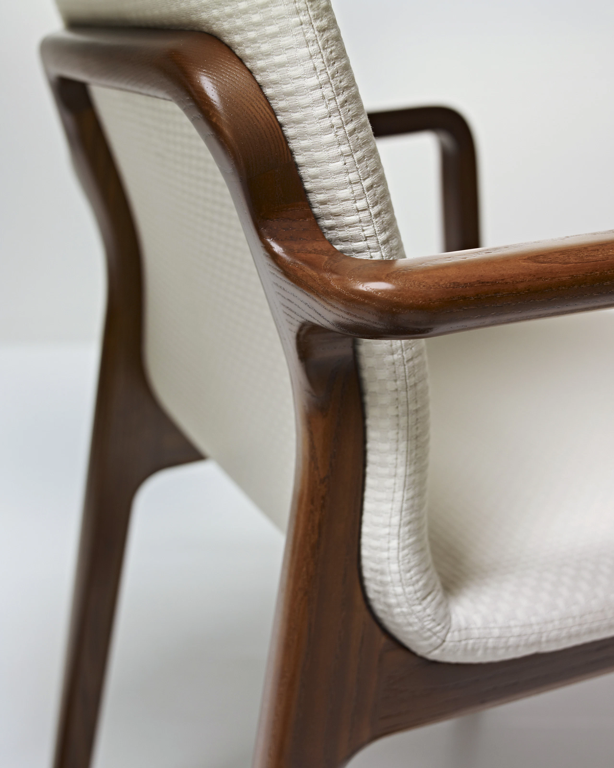 Close-up on a rear corner of a Deft side chair, showing the mortise-and-tenon wood joinery.