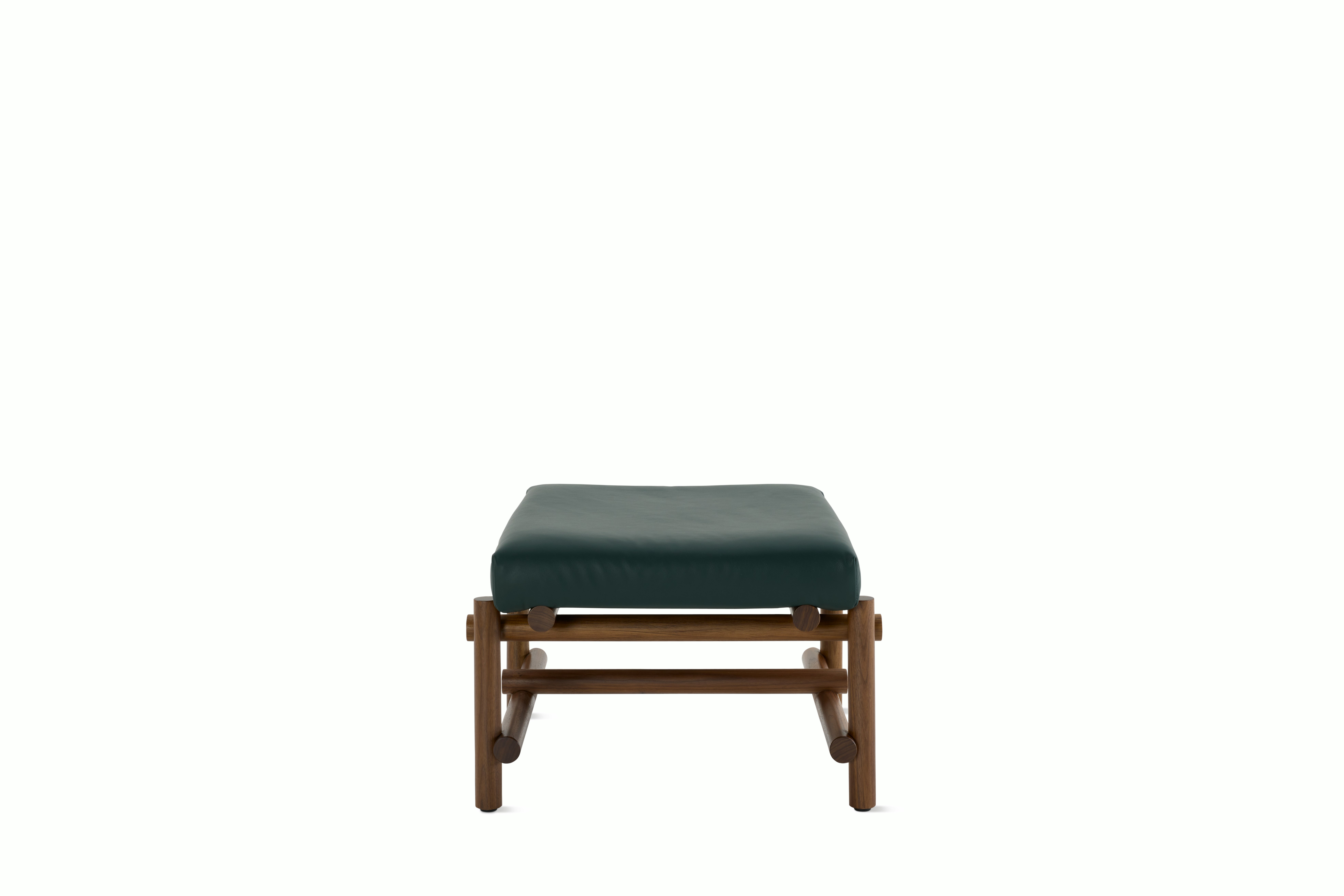 A Muecke Ottoman in Forest Green Walnut viewed from the side.