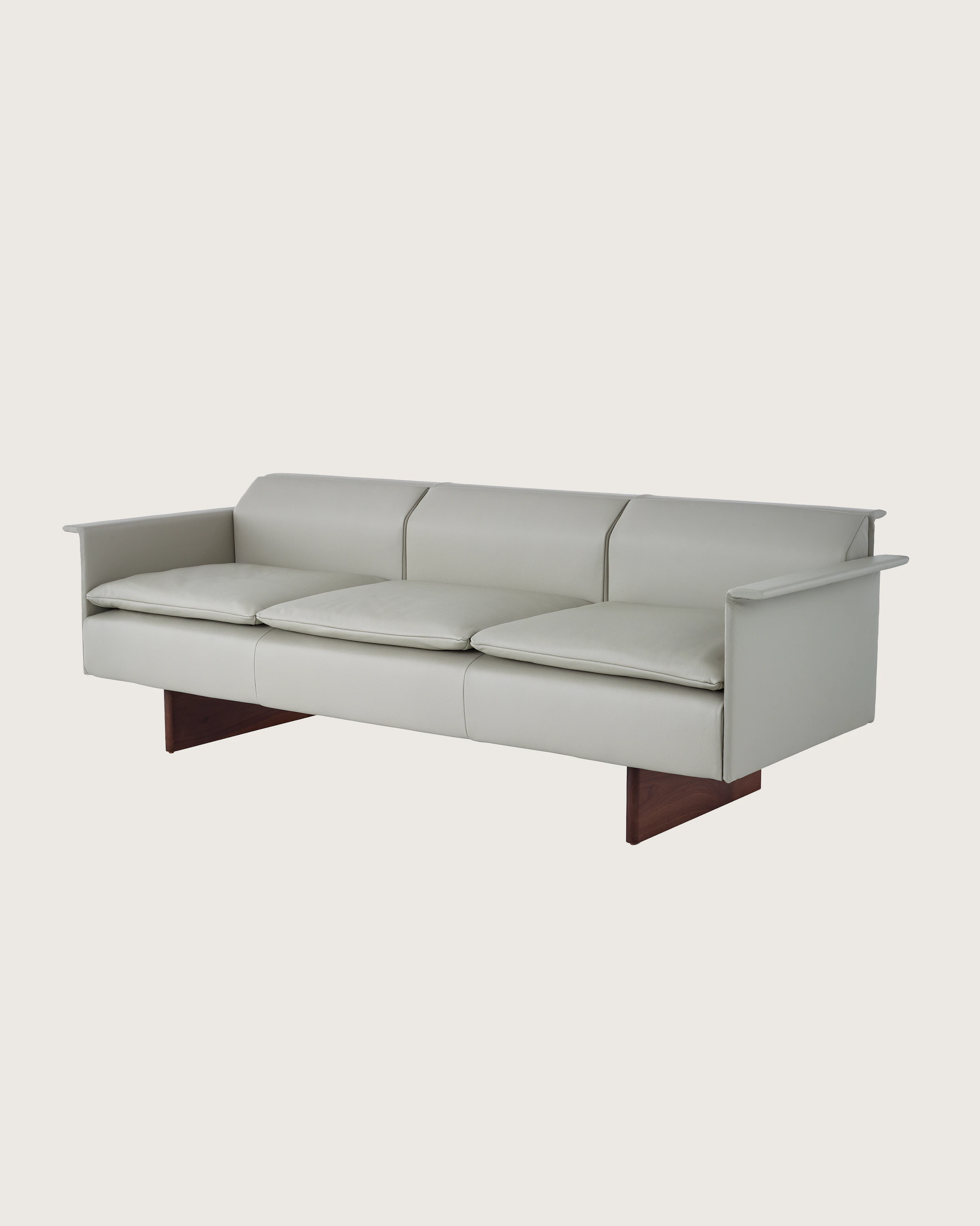 Mantle Three Seater Sofa with Walnut Wood Base in Bristol Leather Ash Gray.