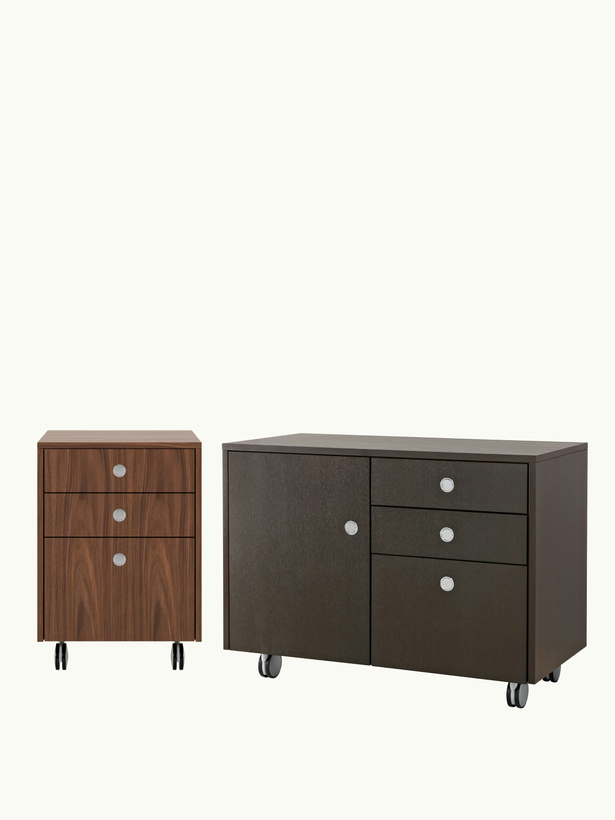 Two Sled Base Storage units designed by Ward Bennett, one pedestal unit with casters front-facing, one credenza with casters viewed at an angle, on a white sweep.