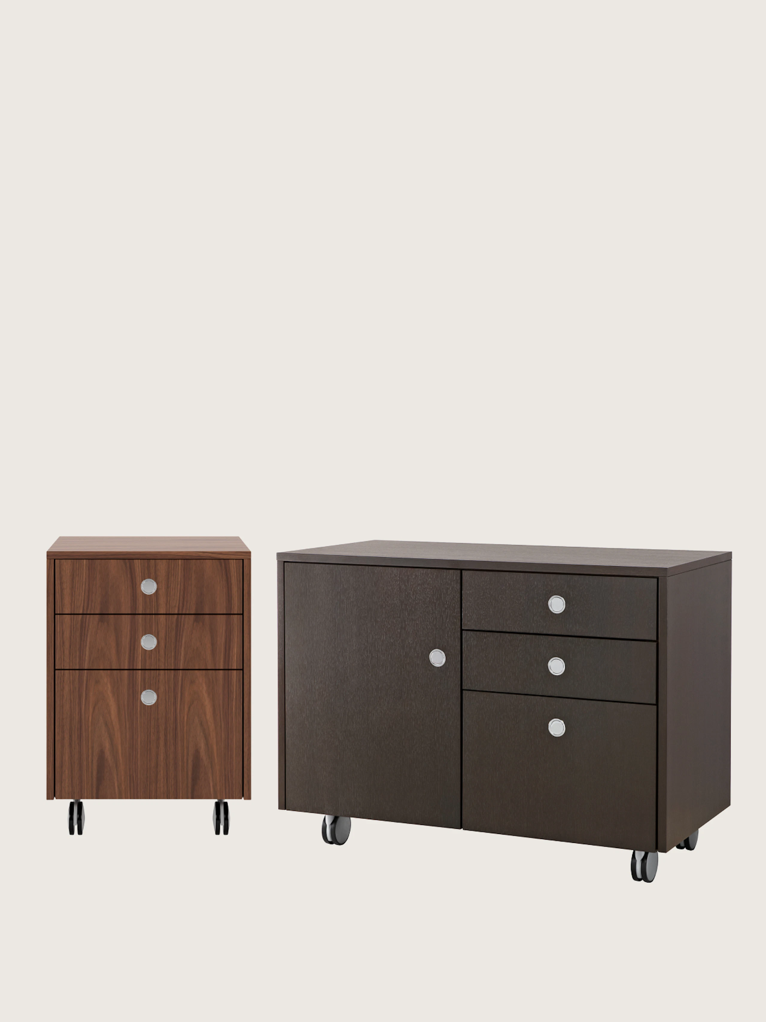 Two Sled Base Storage units designed by Ward Bennett, one pedestal unit with casters front-facing, one credenza with casters viewed at an angle, on a white sweep.