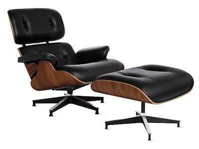 A three quarter front view of a black leather Herman Miller Eames Lounge Chair and Ottoman