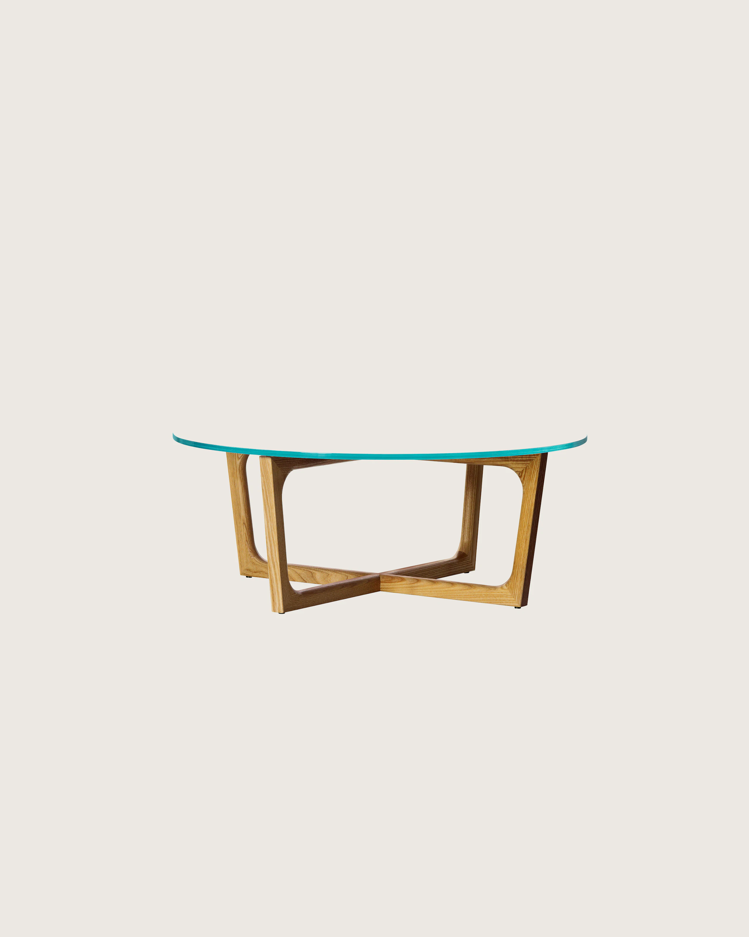 A round Loophole coffee table with a glass top and a walnut base.