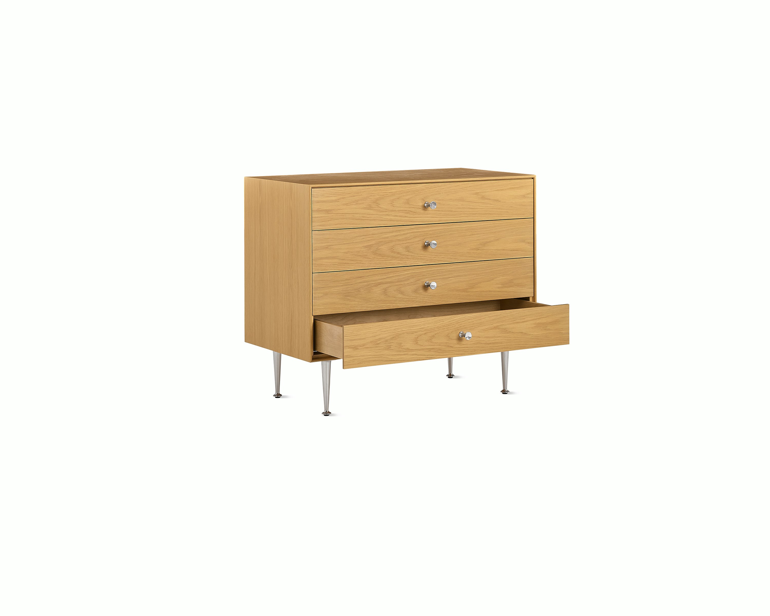 Light brown Nelson Thin Edge Chest with one drawer open, viewed from an angle.