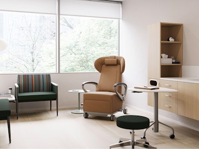 Exam room with casework against the side wall, a recliner, and side seating.