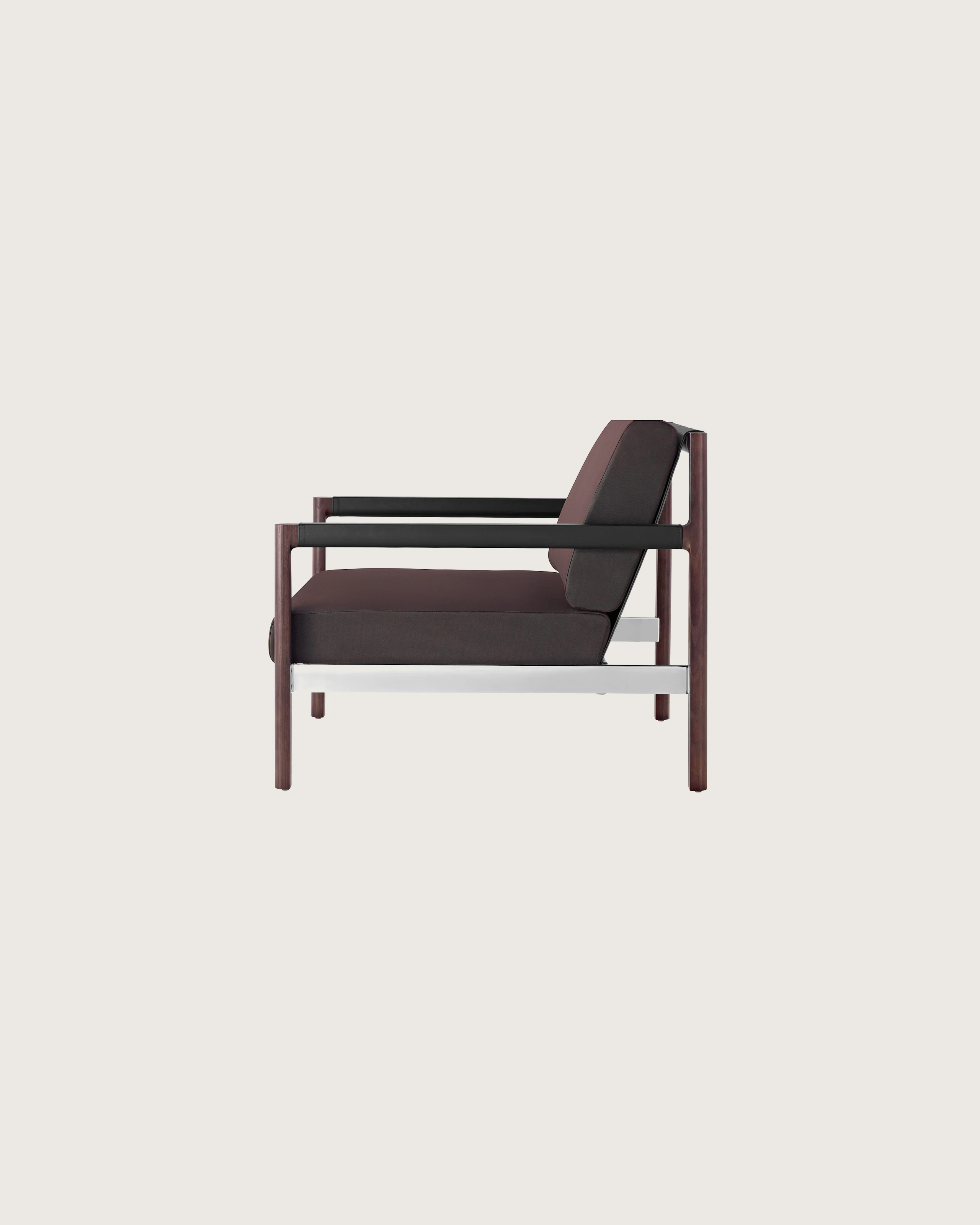 Side view of a Brabo club chair with dark brown upholstery, leather and metal accents, and an exposed wood frame.