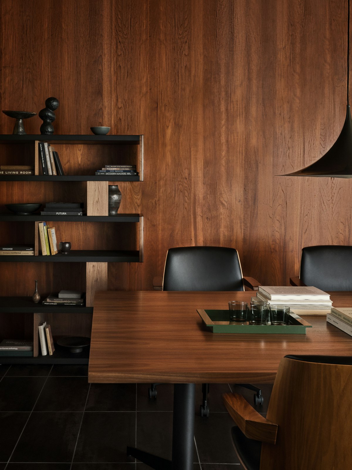 MP Conference Table designed by Amir Paknya for Geiger in Natural Flat Cut Walnut shown with low-back Clamshell Chairs and a New Canaan Bookshelf.